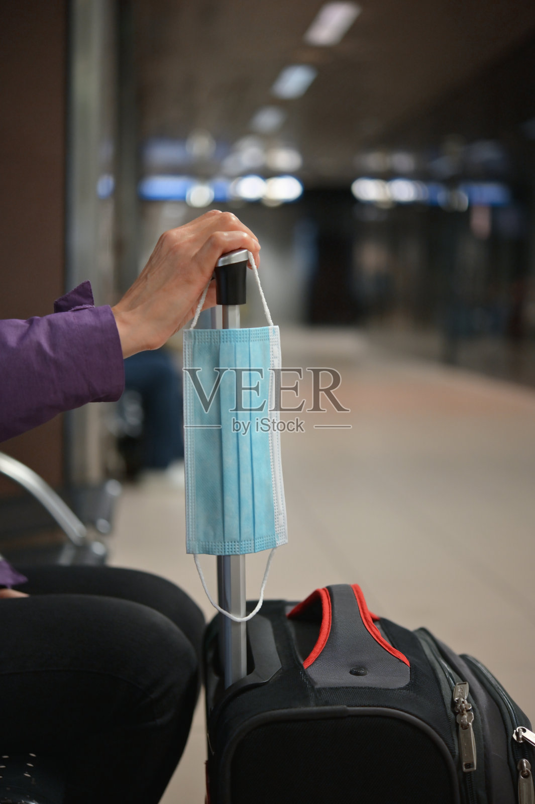 旅行限制戴着口罩和行李等待的女人照片摄影图片