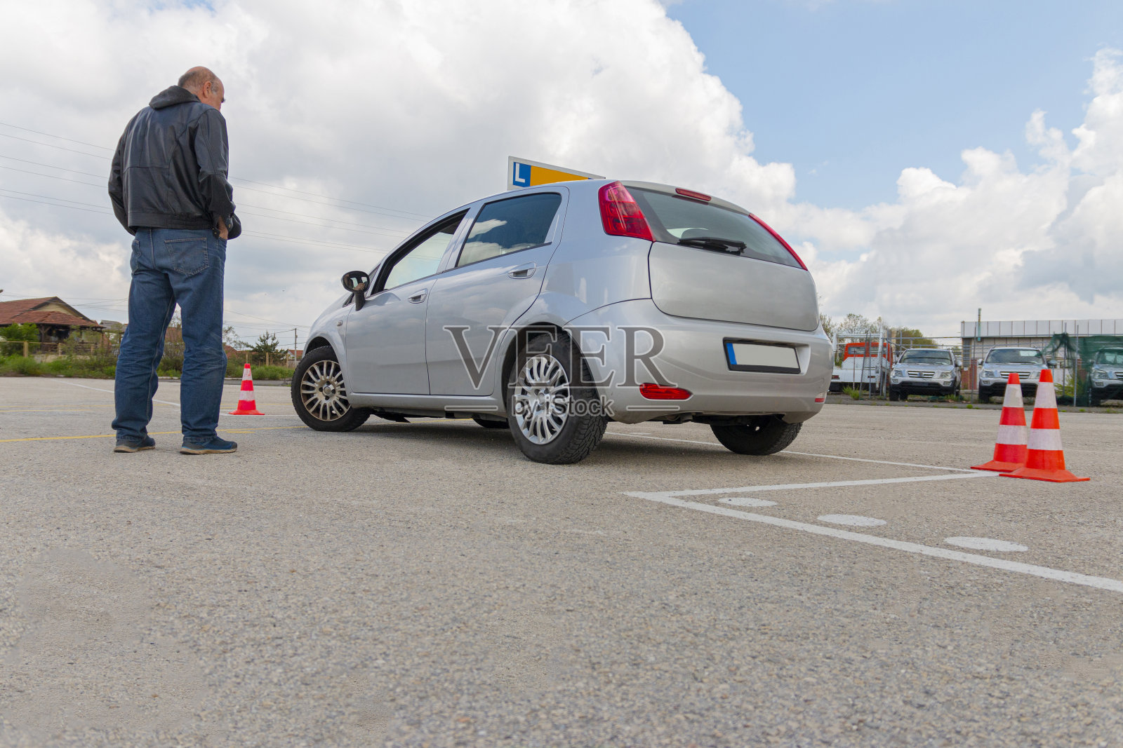 教练在考生为驾驶考试进行练习时观察她。照片摄影图片