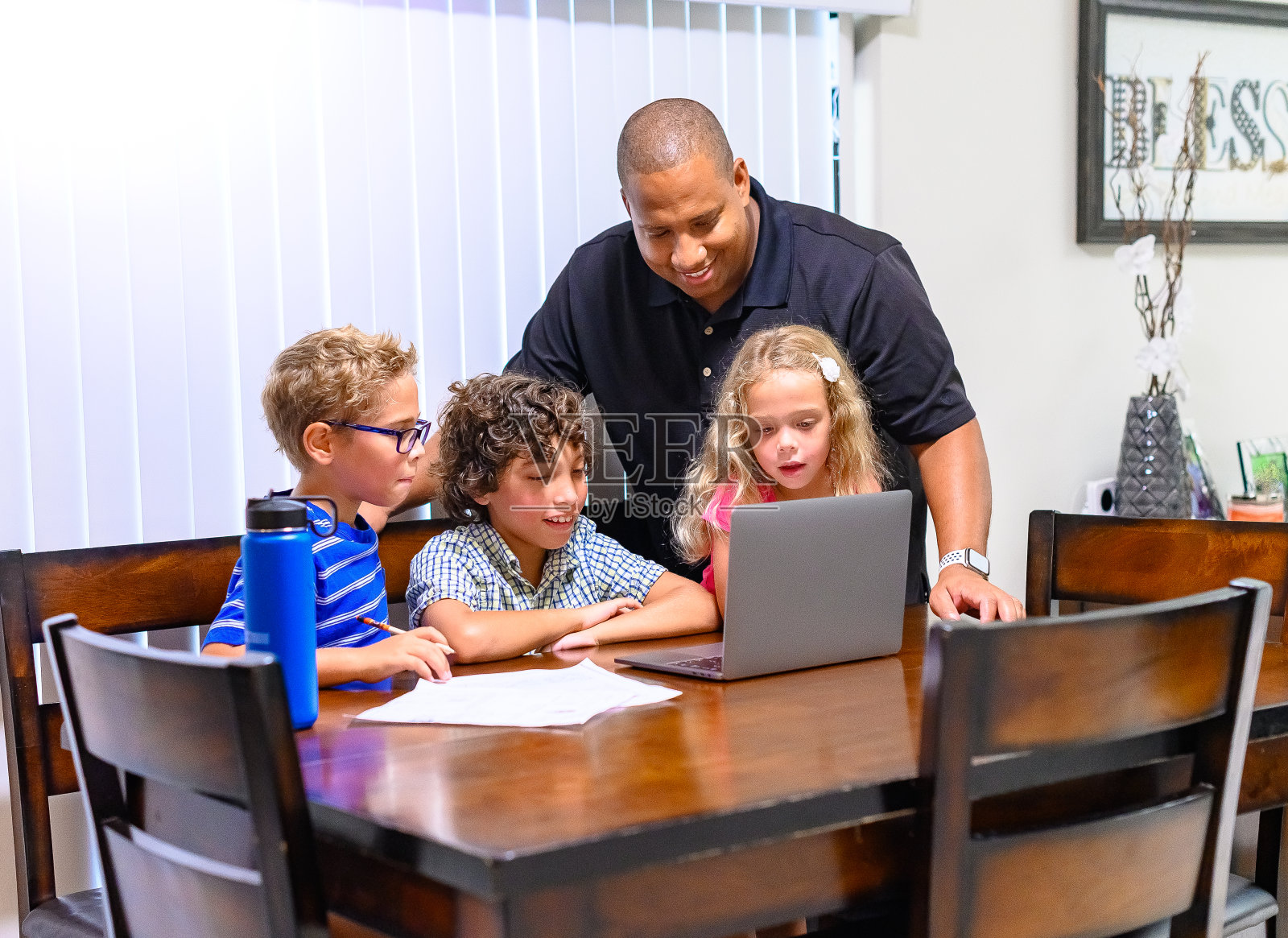 爸爸和孩子在家里一起用笔记本电脑看东西照片摄影图片