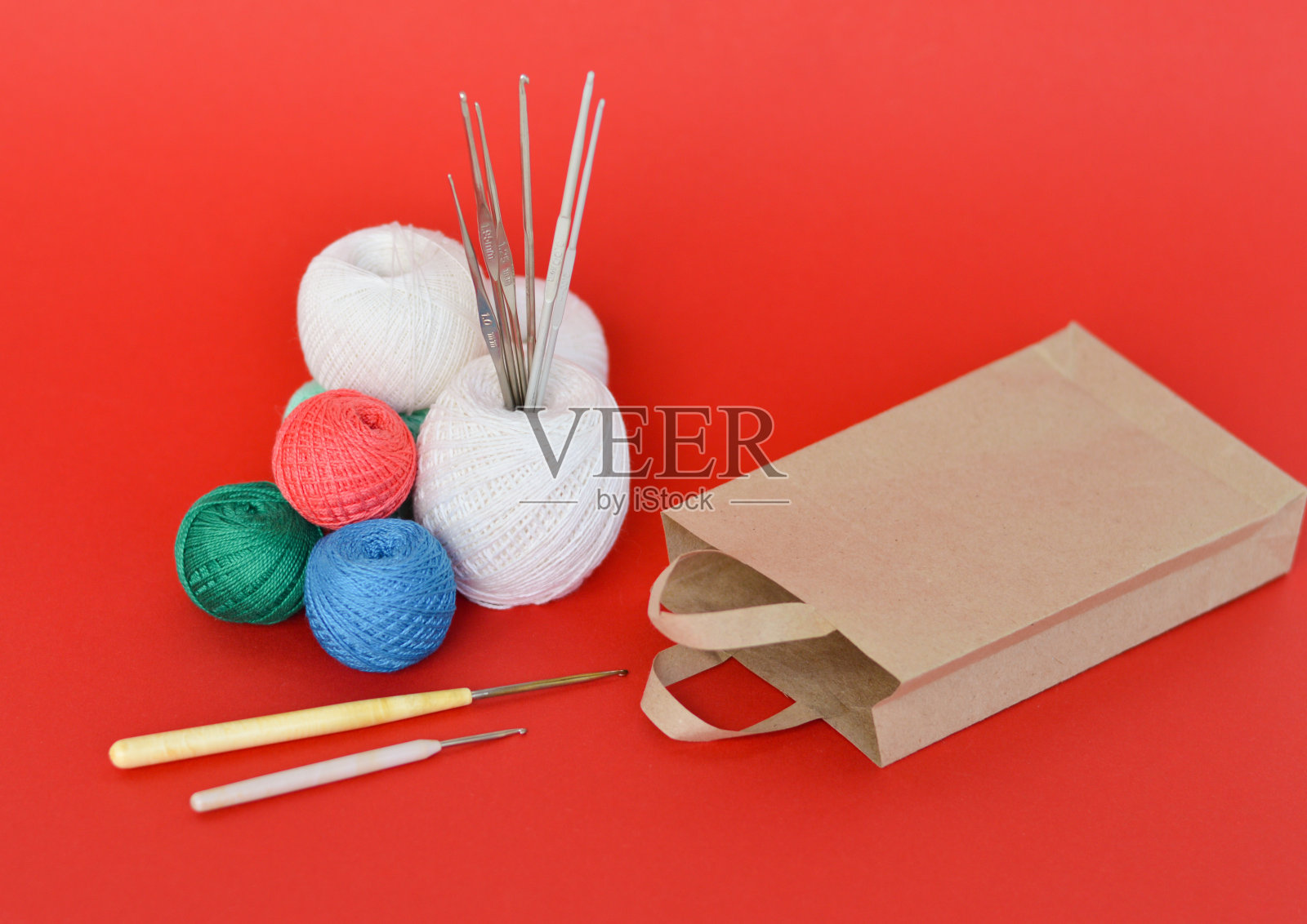 一个特写镜头的红色，紫色和蓝色针织纱线和钩针照片摄影图片