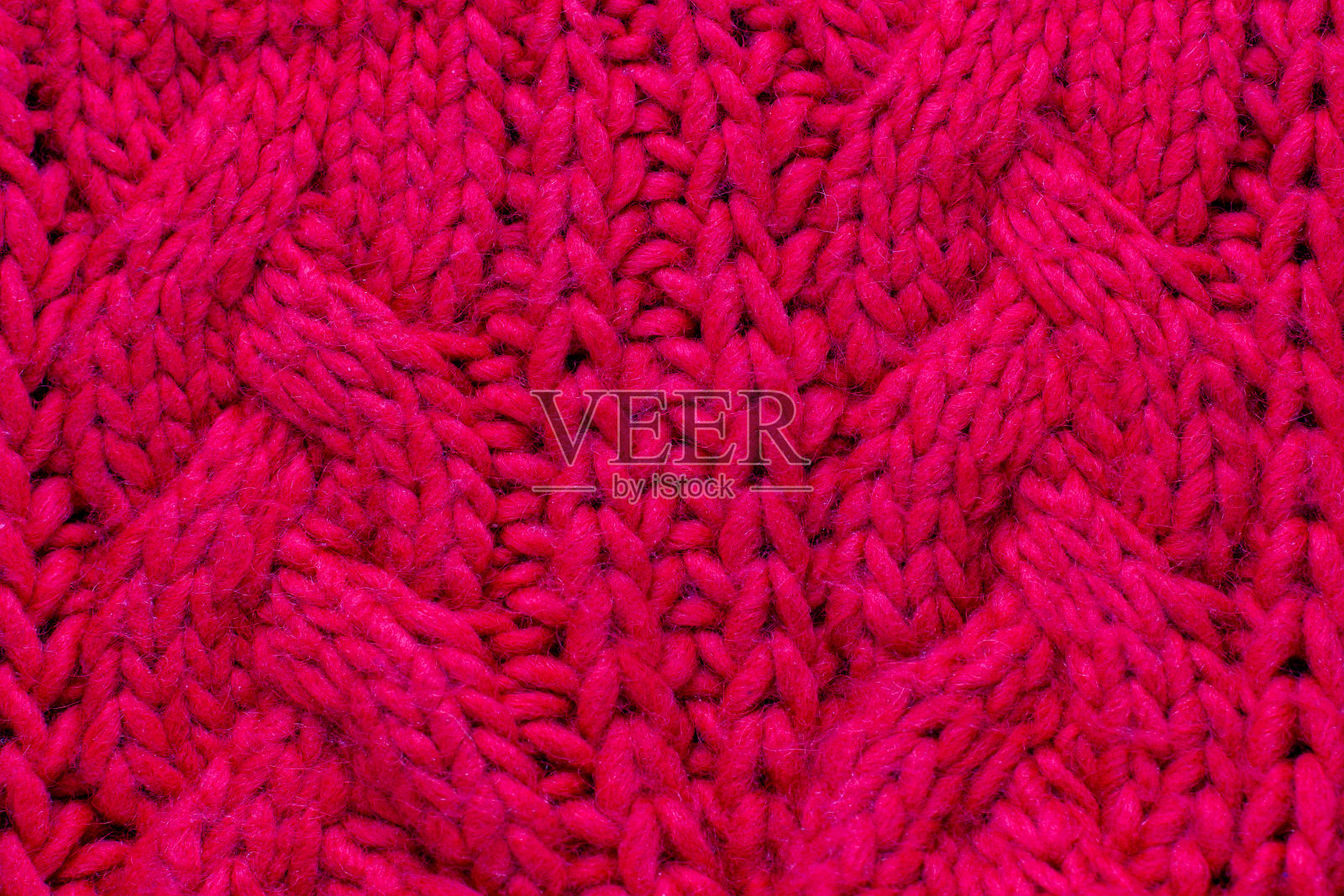 红色针织羊毛背景为您的设计。毛衣的针织织物图案照片摄影图片