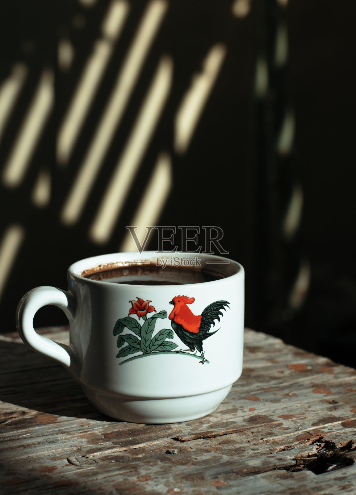 外面阳光明媚的早晨，一杯咖啡放在木桌上。照片摄影图片