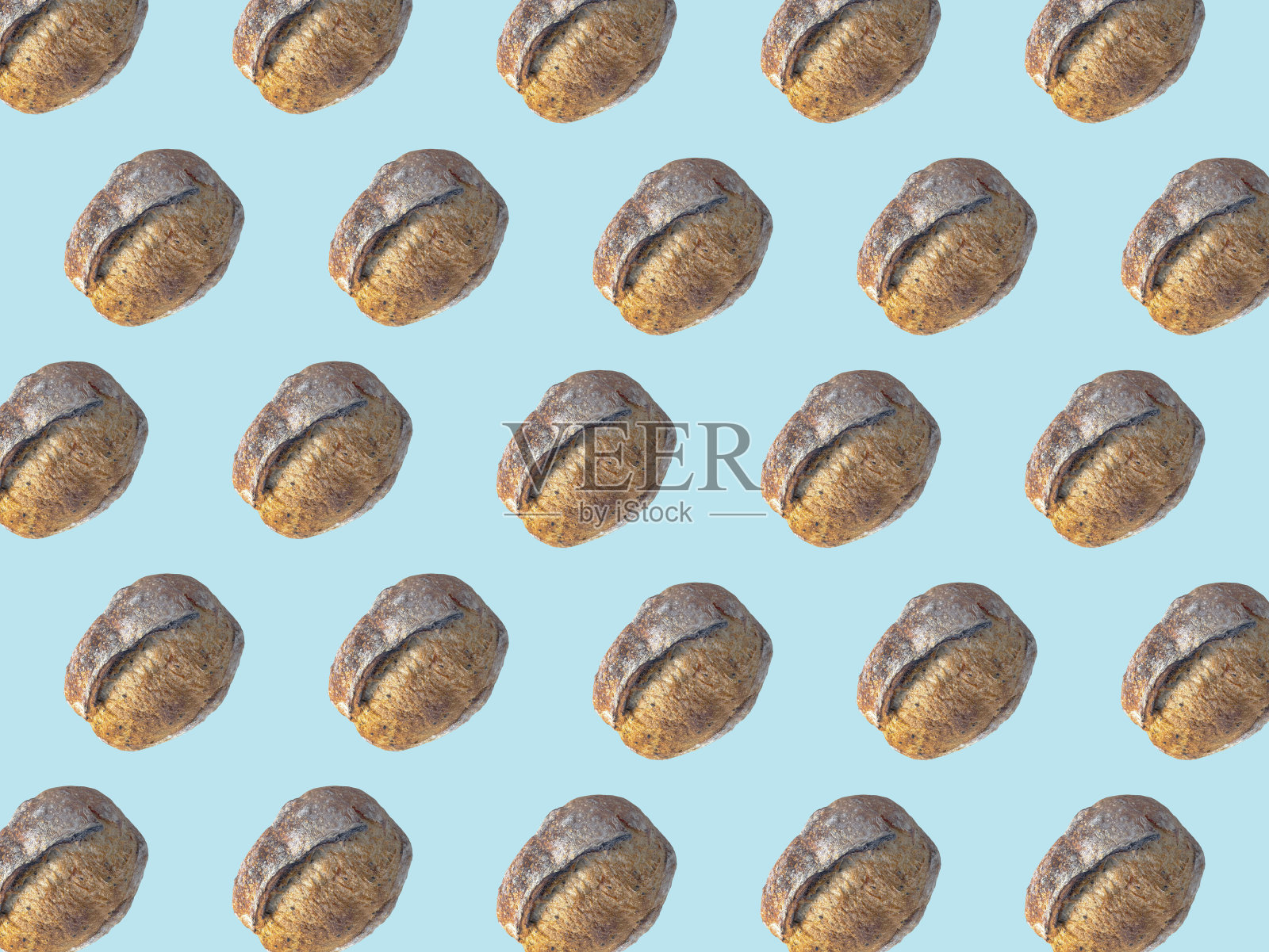 背景艺术设计，棕色自制酵母面包图案，浅蓝色背景照片摄影图片