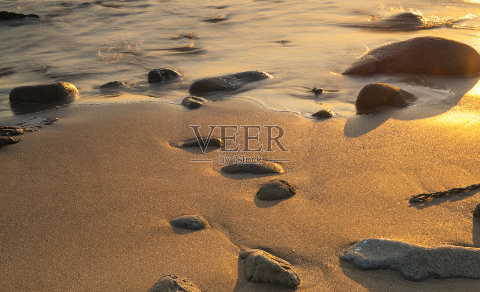 卵石被海浪冲刷。照片摄影图片