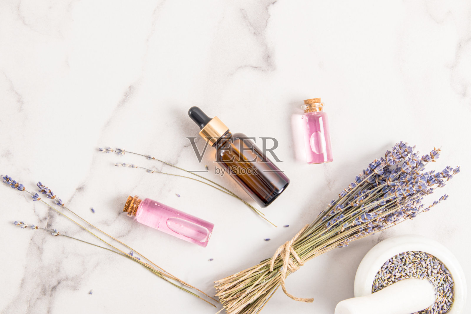 有机薰衣草油或乳清，玻璃瓶薰衣草水。前视图。天然的化妆品。照片摄影图片