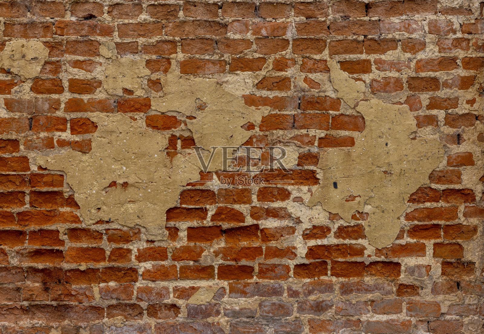 破旧的砖墙背景上有旧的石膏污渍照片摄影图片