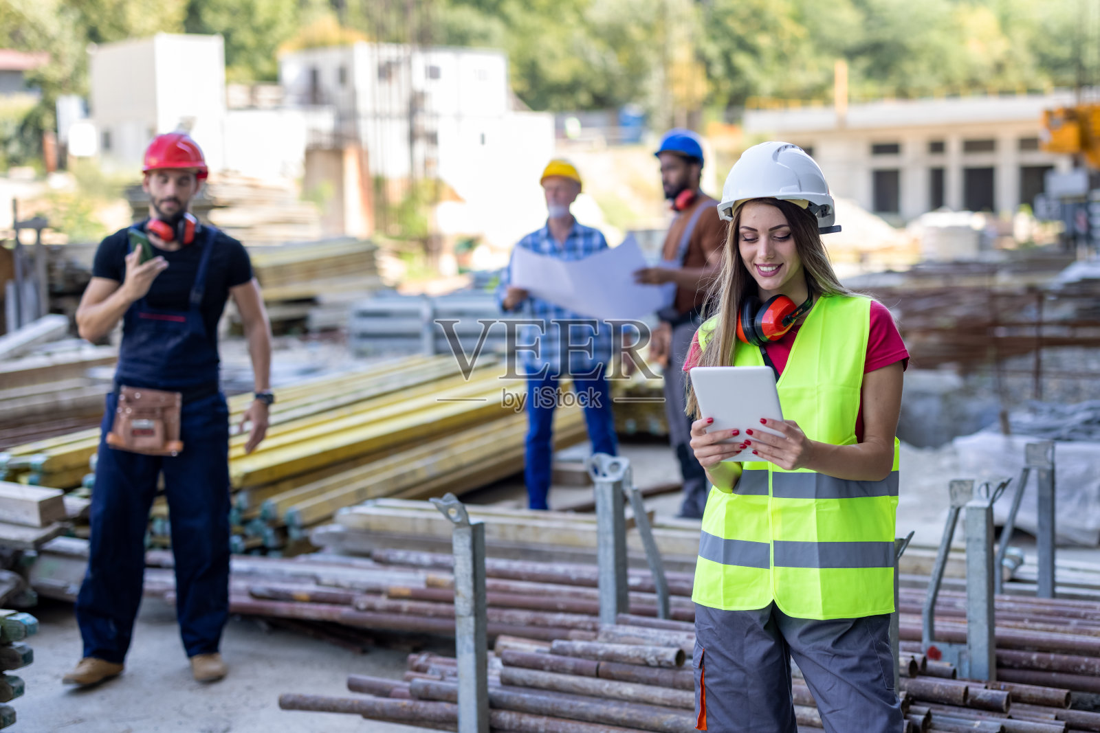 一群同事正在用平板电脑做建筑项目。照片摄影图片