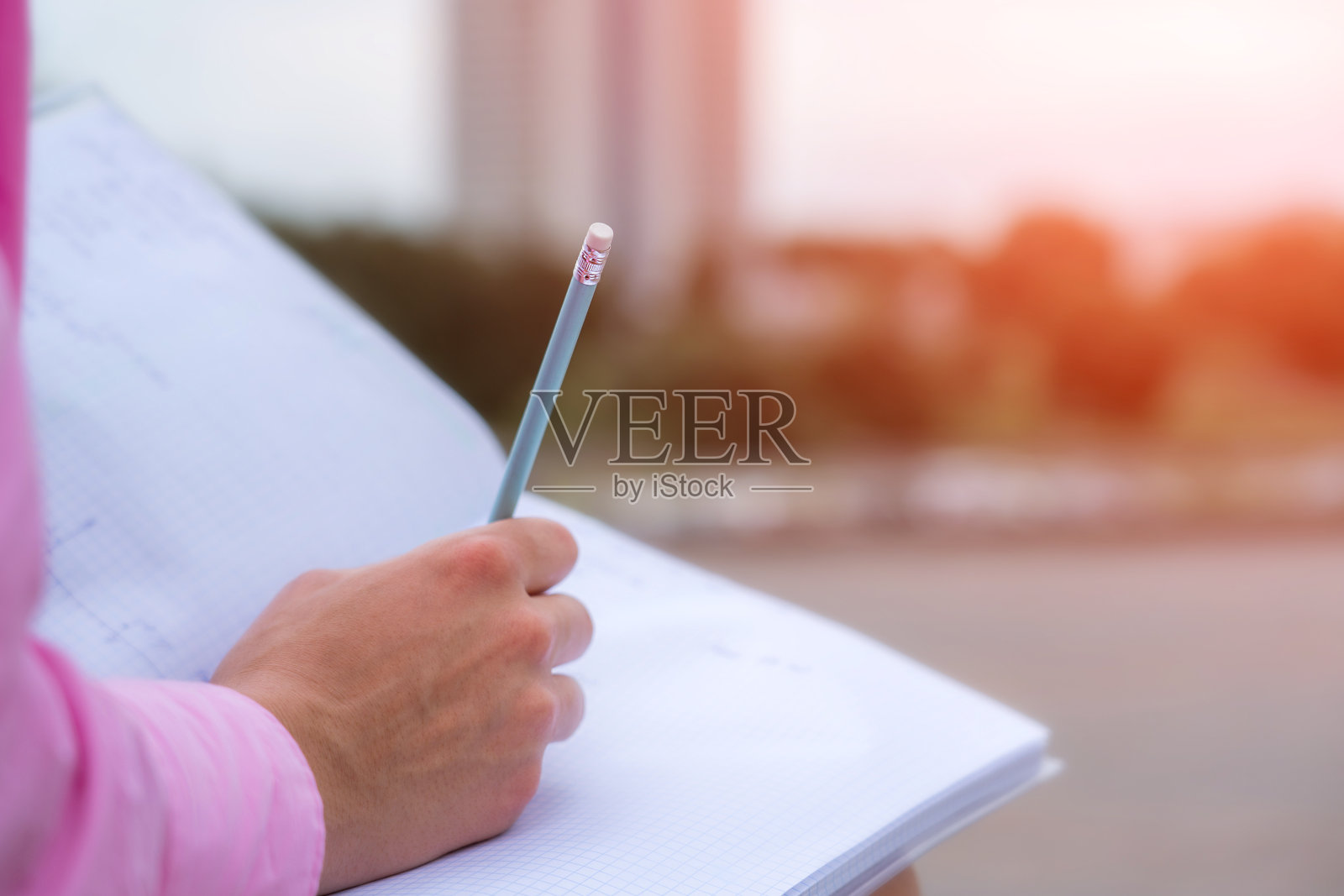 学生女生用铅笔在打开笔记本近距离观察照片摄影图片