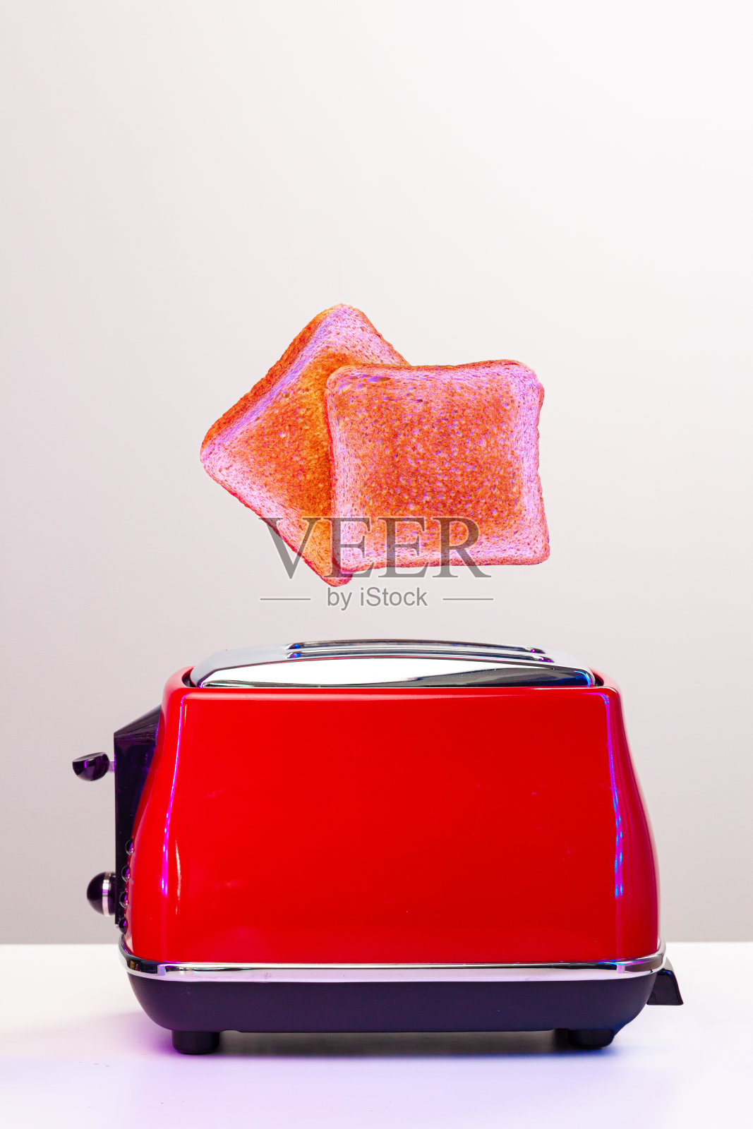 两片烤面包片在霓虹灯下跳出烤面包机照片摄影图片