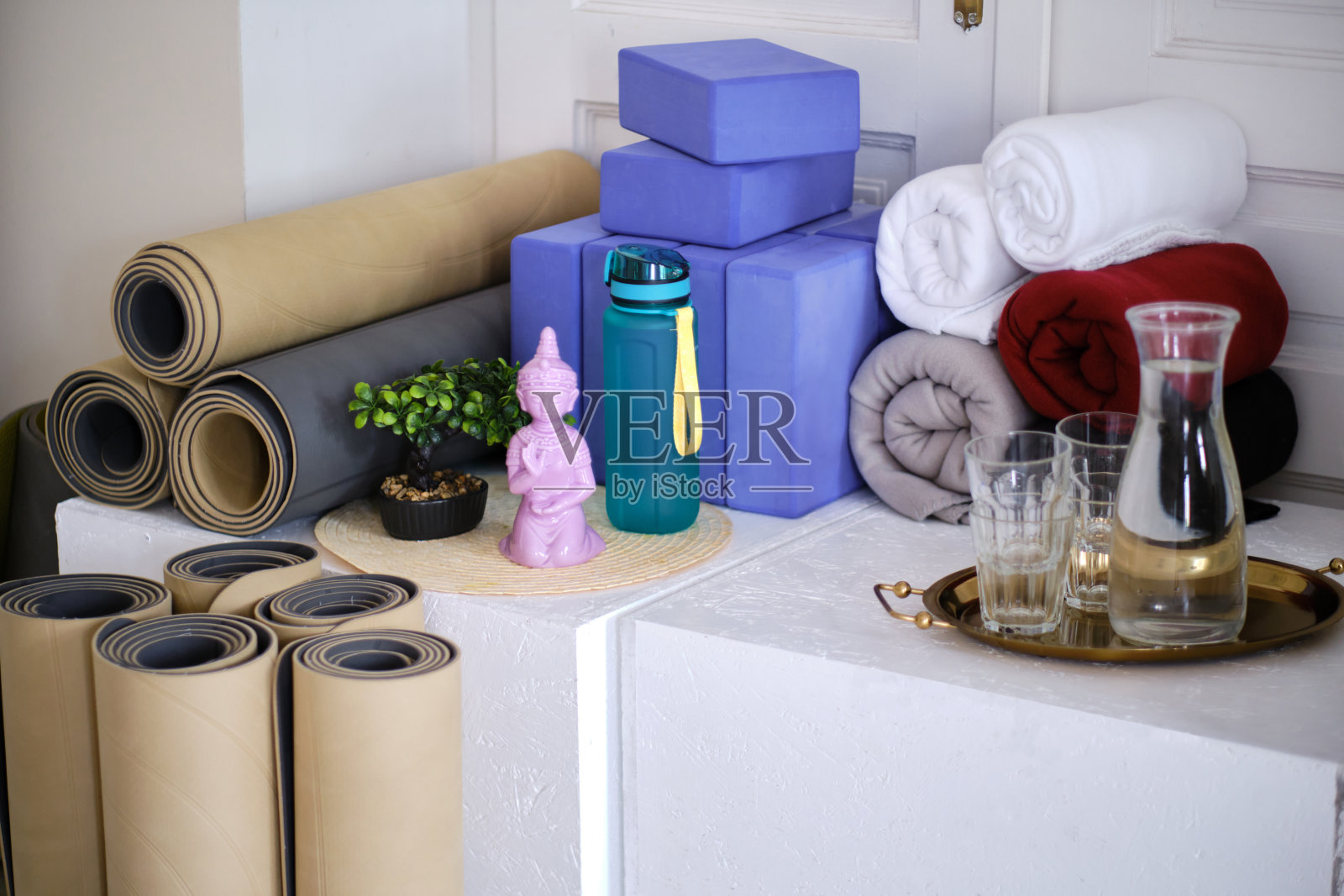 瑜伽馆的运动器材。用于瑜伽、冥想或健身的卷垫子、积木和毛巾。照片摄影图片