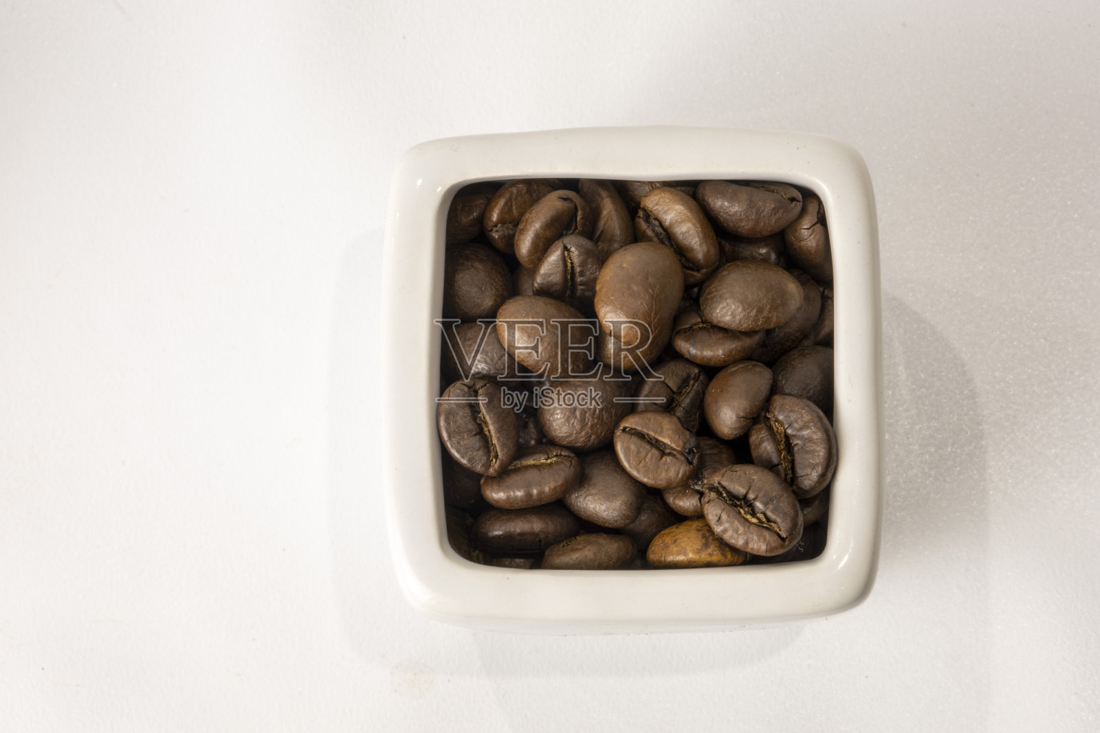 白底咖啡壶里的咖啡豆照片摄影图片