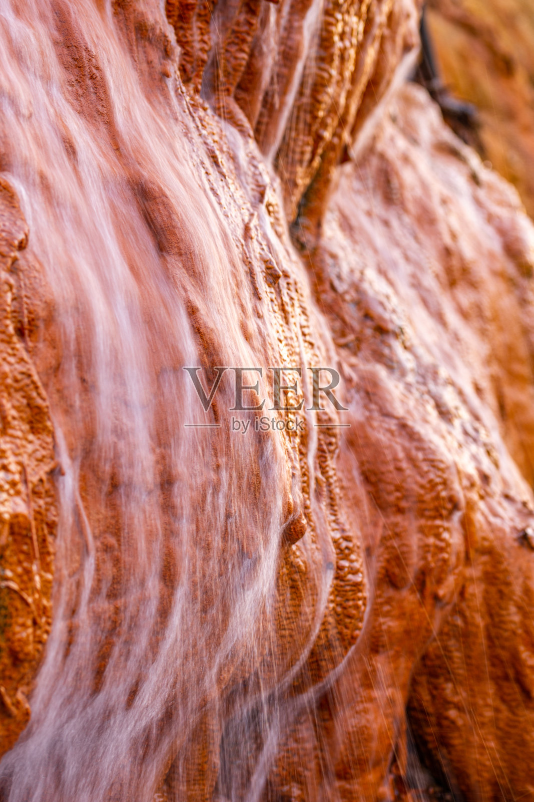 特写长时间暴露的流动的水从潮湿的岩层在森林照片摄影图片