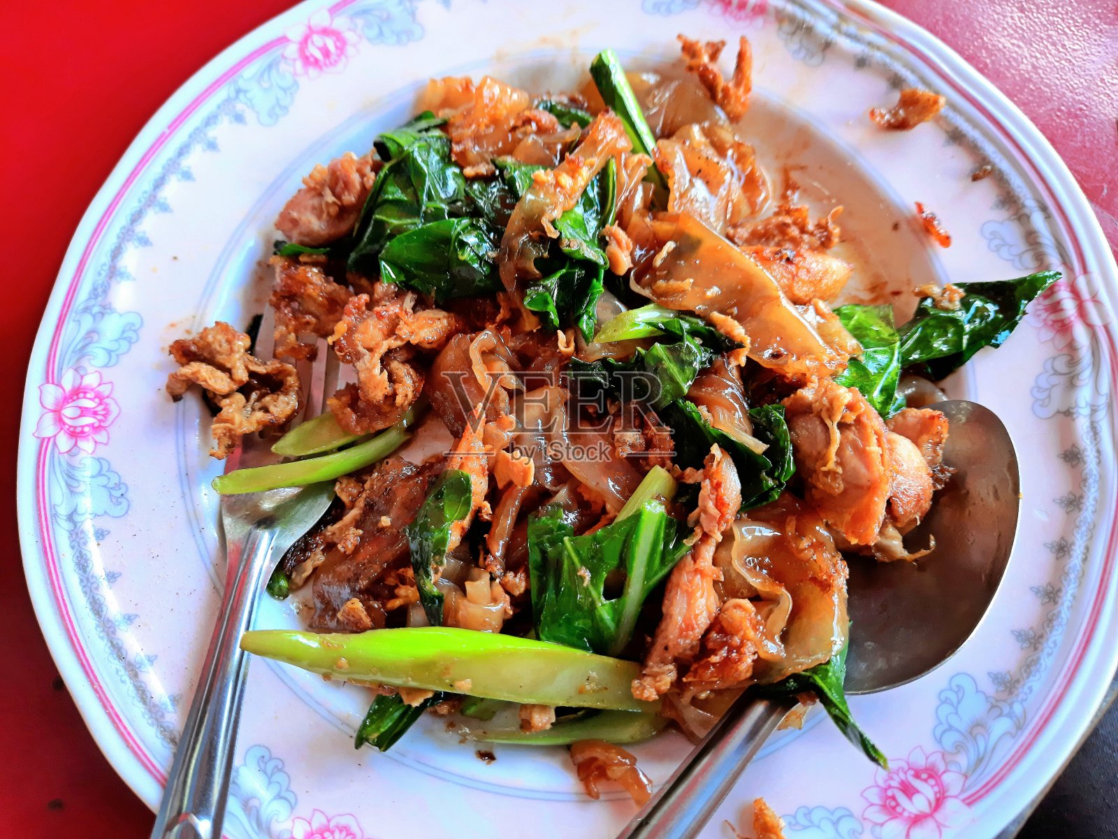 吃甘蓝猪肉炒面-曼谷街头的食物。照片摄影图片