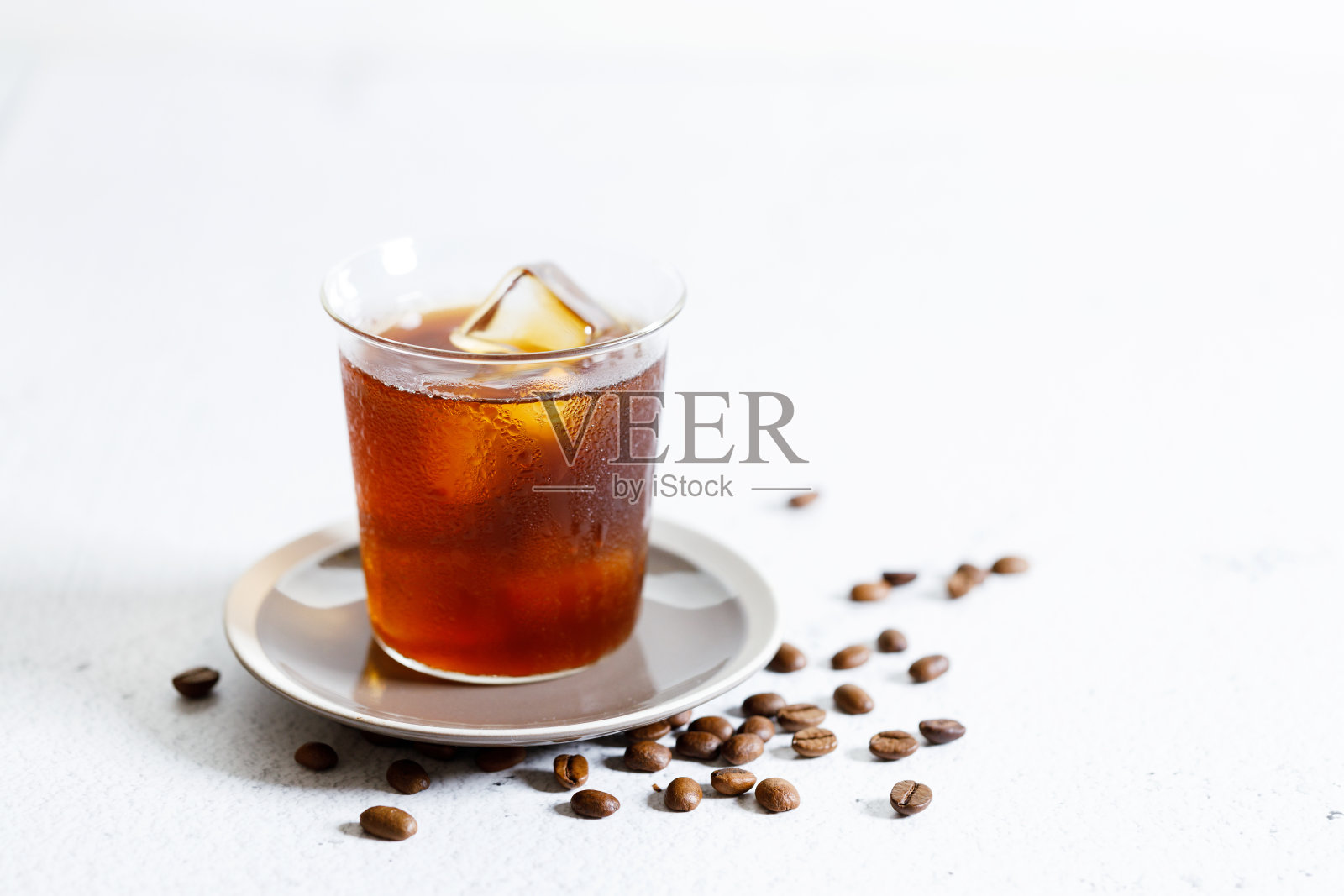 白色大理石桌子上的冰咖啡。照片摄影图片