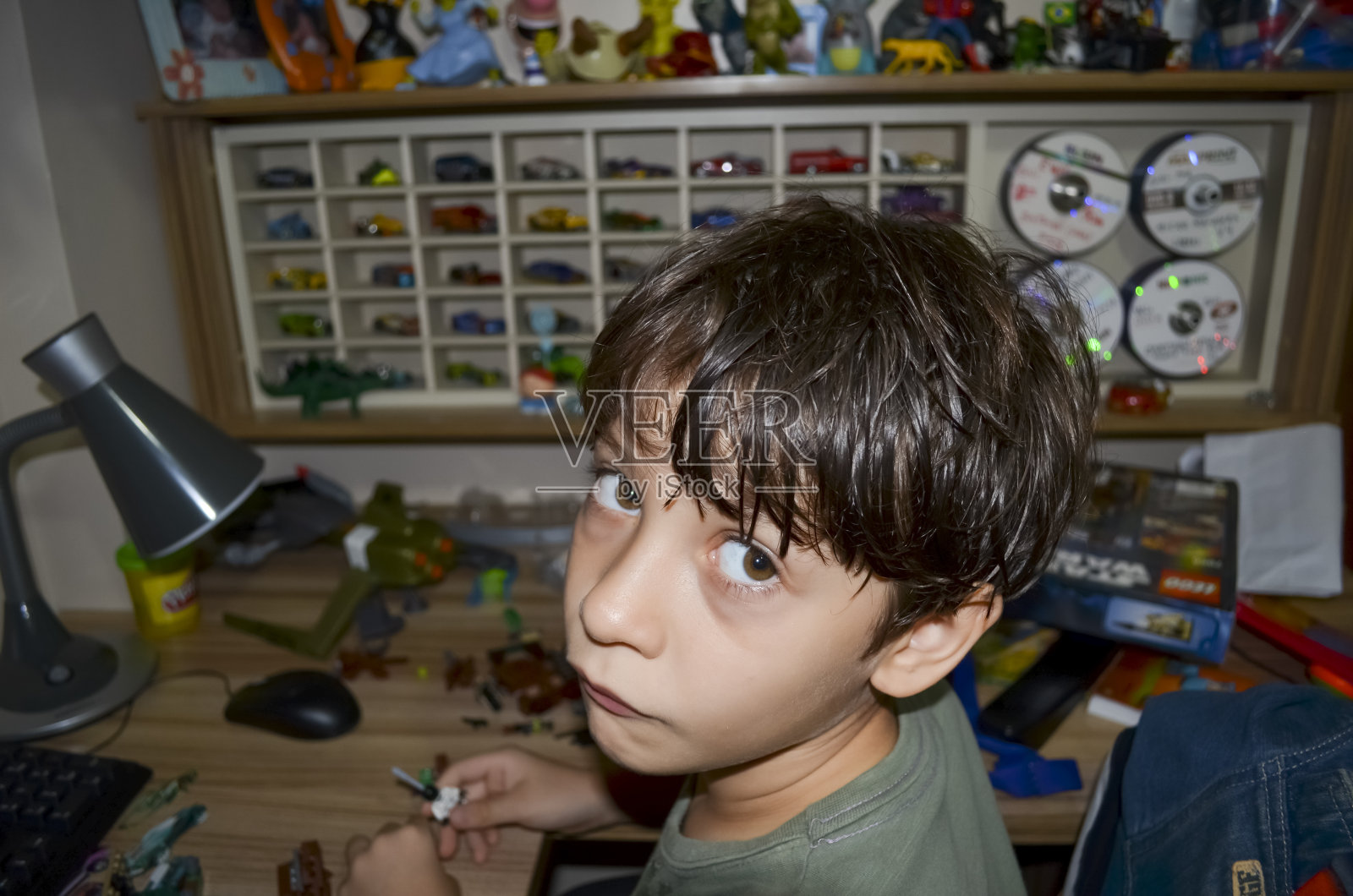 一个孩子的肖像在房间里玩，看着镜头。照片摄影图片