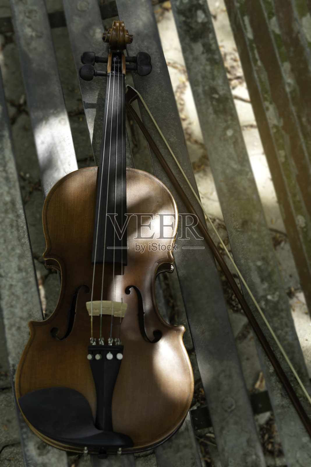 小提琴和中提琴放在场地的长凳上，在练习休息时间为音乐会做准备。照片摄影图片