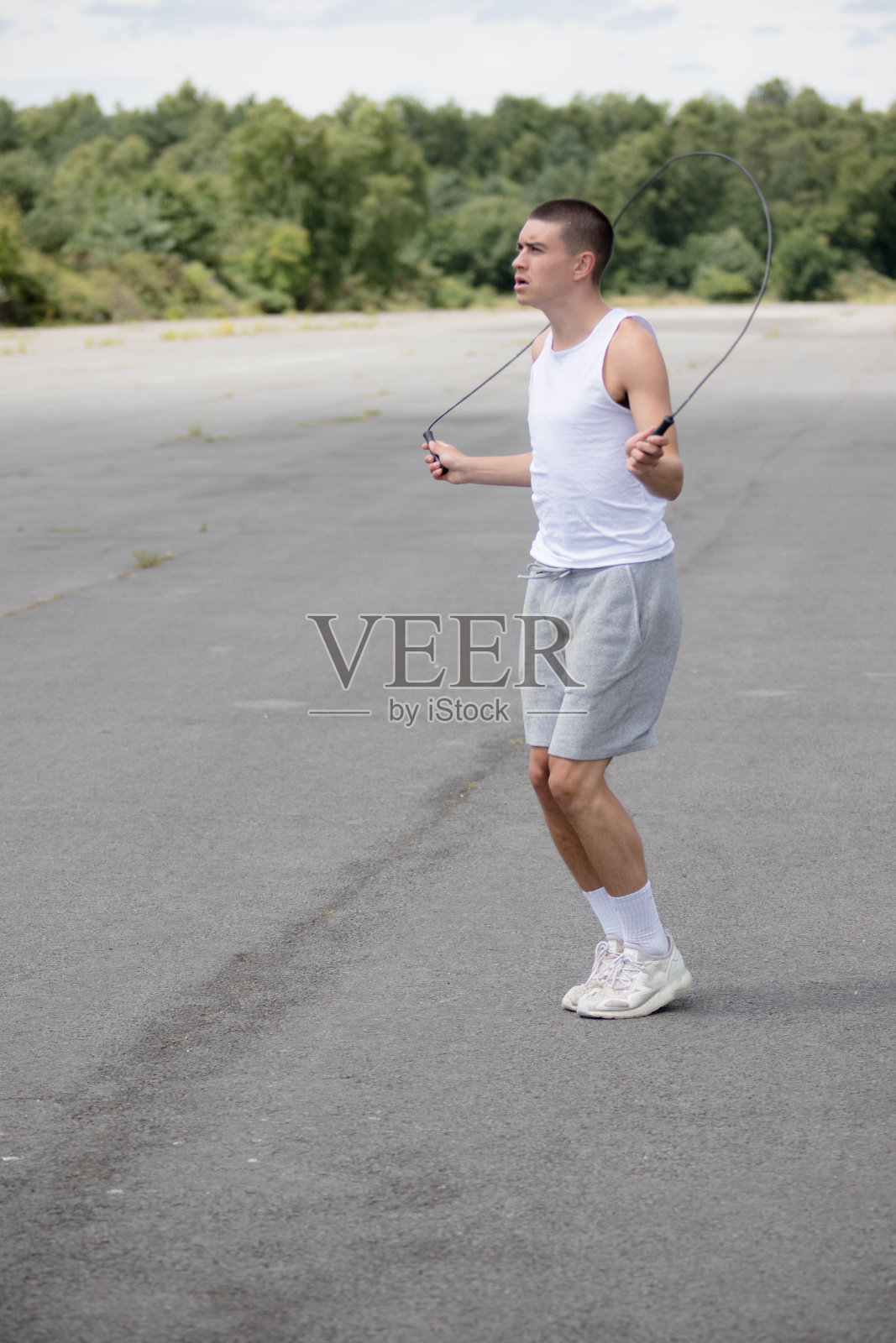 一个19岁的男孩在公园里跳绳照片摄影图片