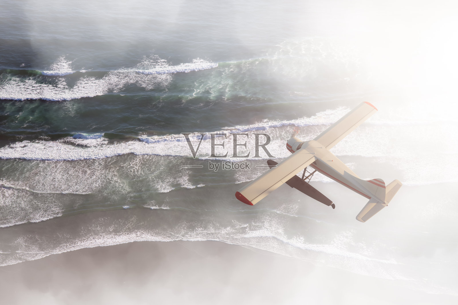 日落时飞越西海岸太平洋的水上飞机照片摄影图片