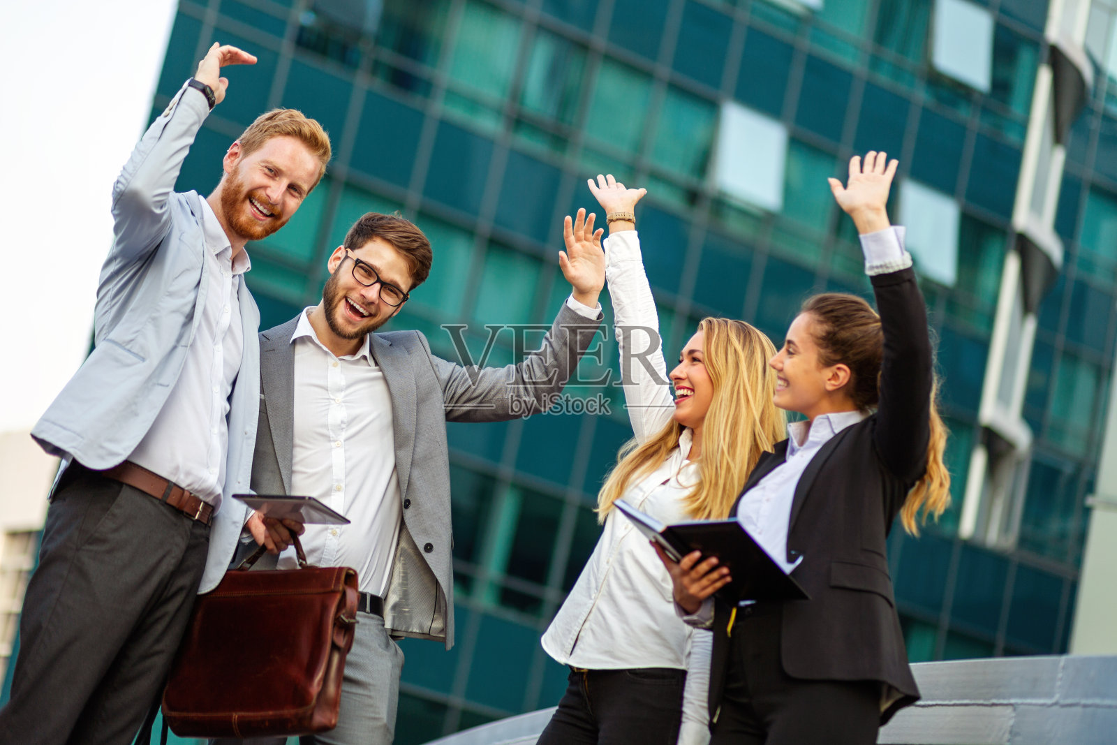 一群快乐成功的商业人士举起他们的手臂欢呼照片摄影图片