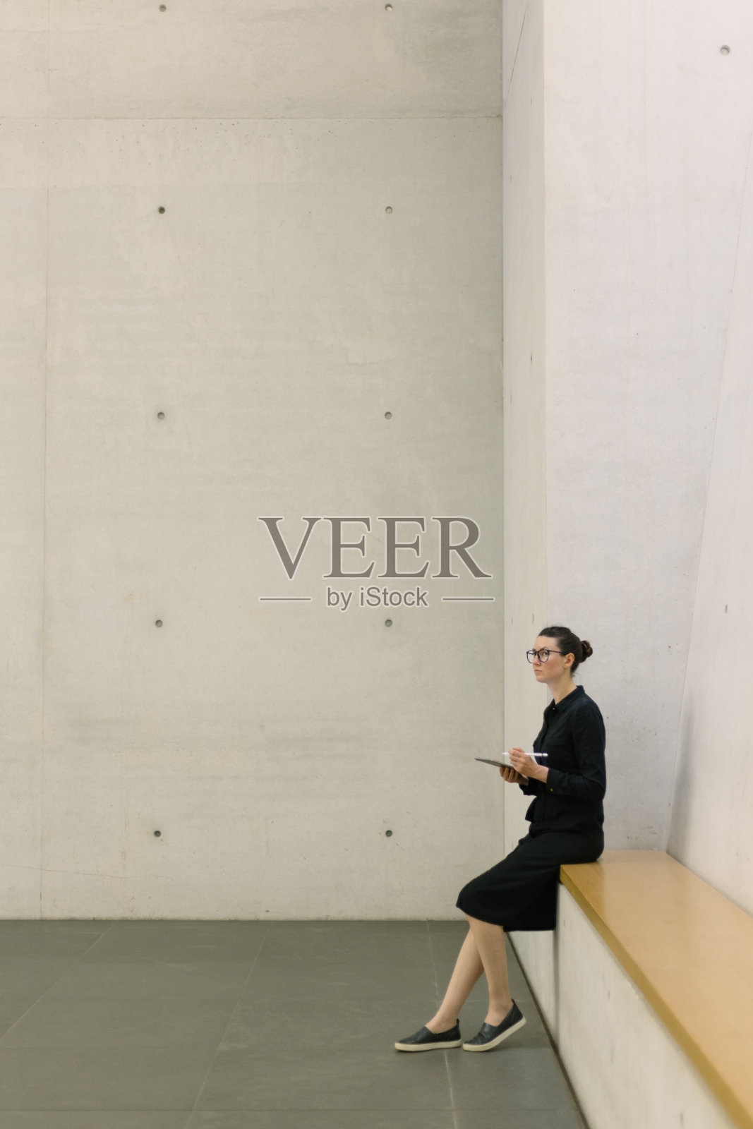 商务女性在极简办公室内使用平板电脑照片摄影图片