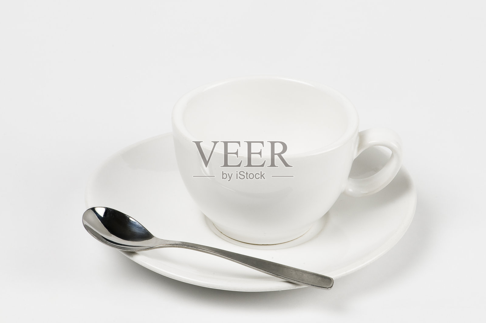 一个空的白色咖啡杯，有盘子和勺子照片摄影图片