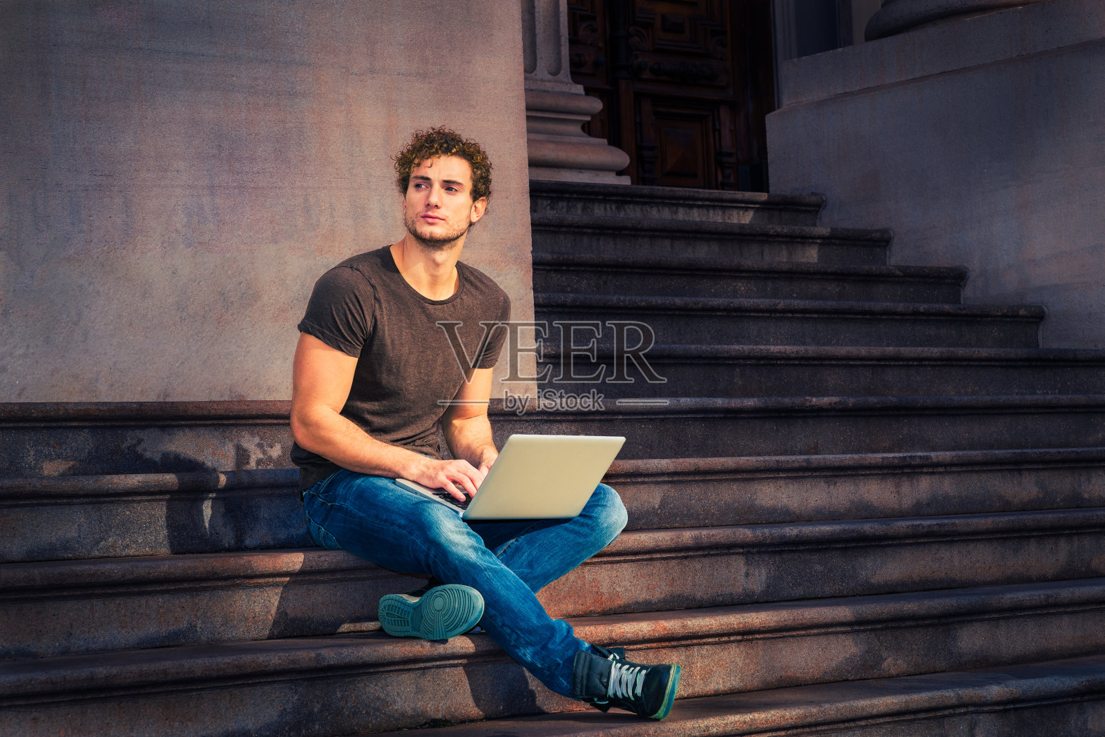 一个在纽约户外用笔记本电脑工作的年轻人照片摄影图片