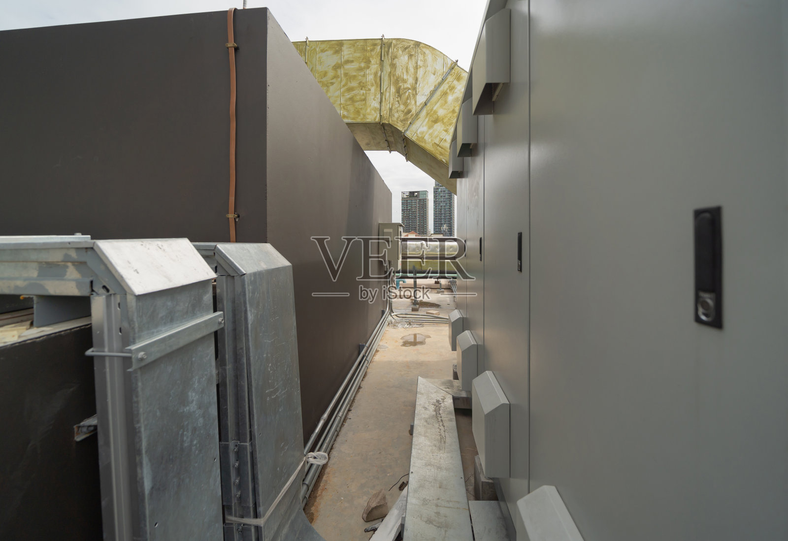 城市办公楼屋顶上的冷却塔或冷却塔。系统的工作。建筑机器。冷凝器供回水管路。通风式压缩机。照片摄影图片