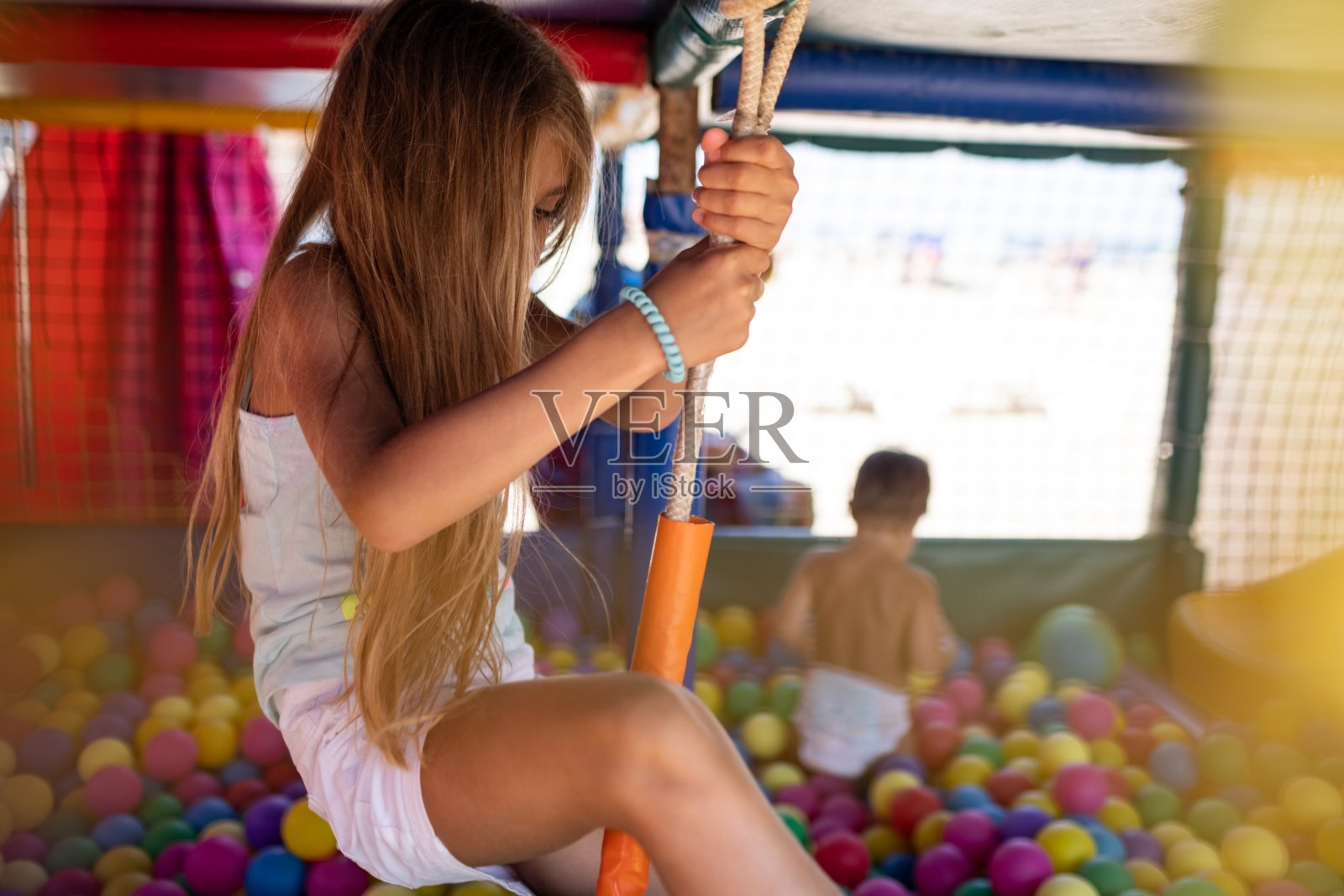 穿着t恤的女孩在游戏室里享受夏日照片摄影图片