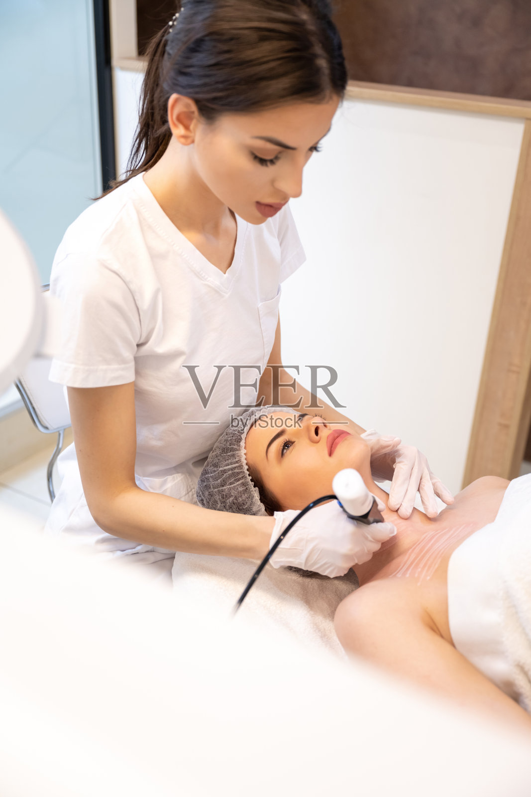 在一家美容诊所，一名女患者正在接受一名医生进行的返老还嫩手术照片摄影图片
