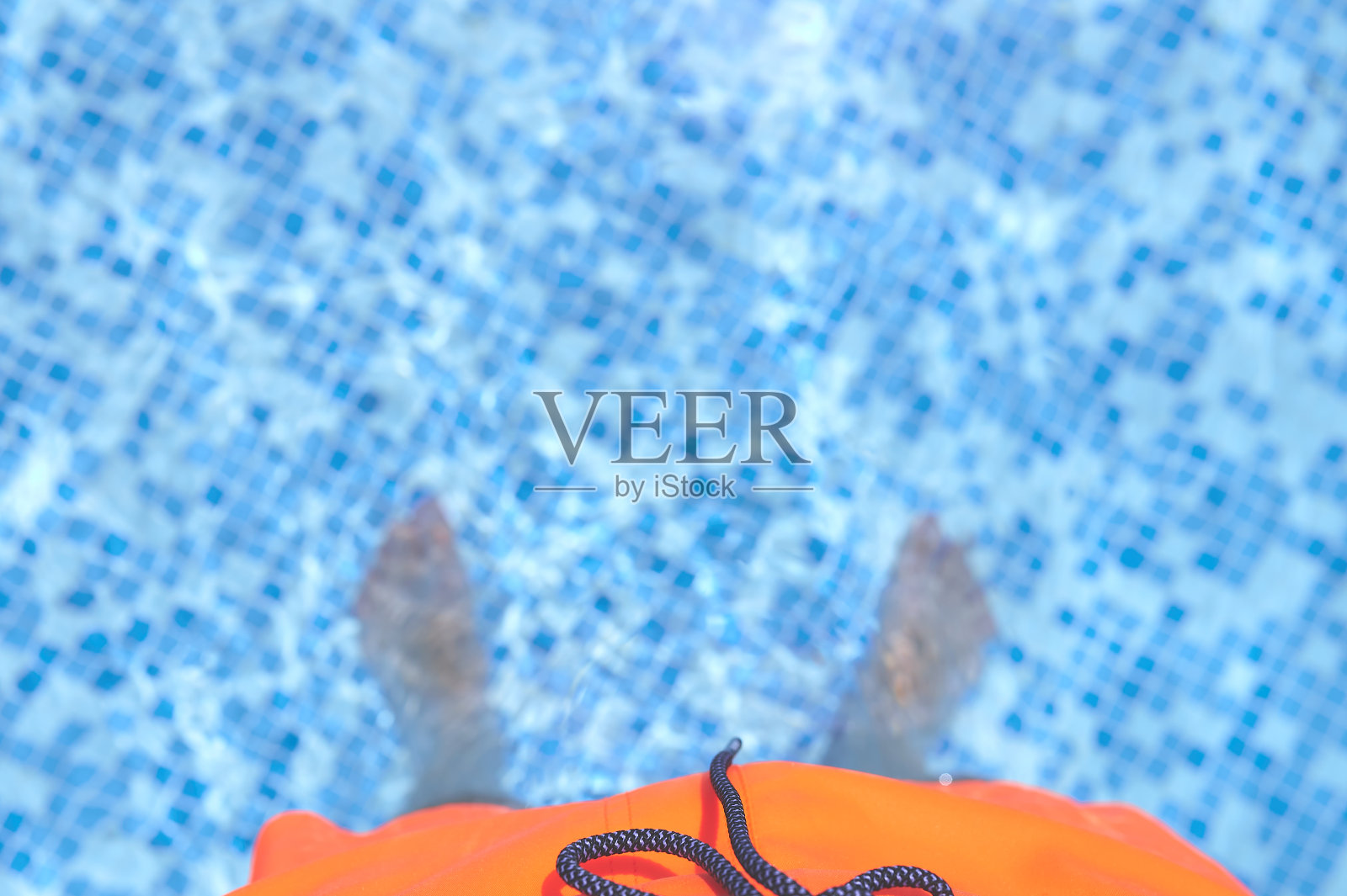 一个穿着泳衣的人在游泳池里的脚照片摄影图片