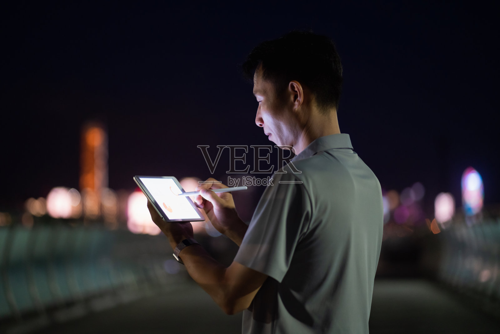男人在晚上使用平板电脑照片摄影图片