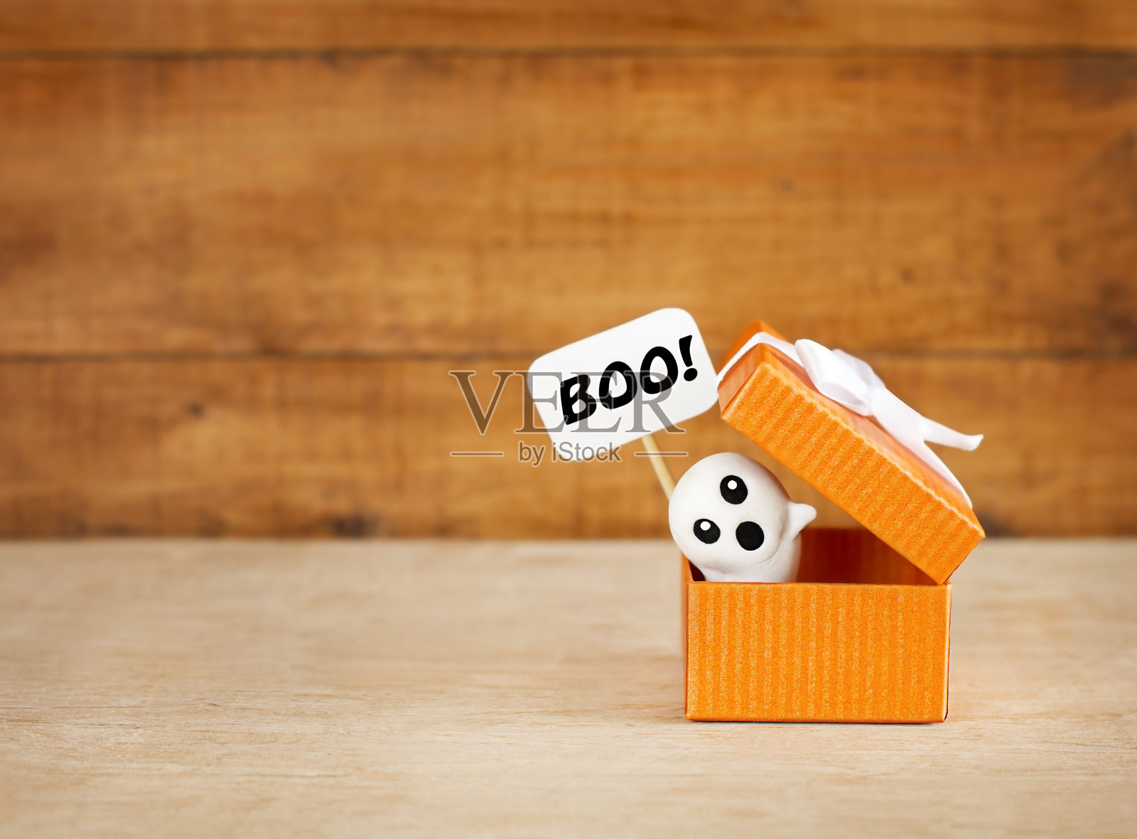 木制背景的礼品盒里有幽灵在偷看照片摄影图片