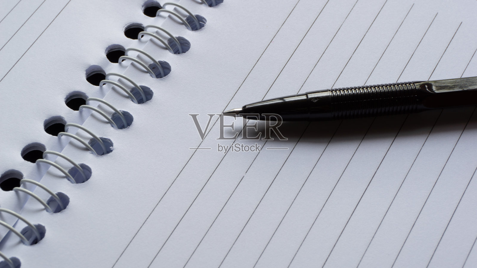 黑色墨水笔在笔记本上。钢笔在办公桌上照片摄影图片