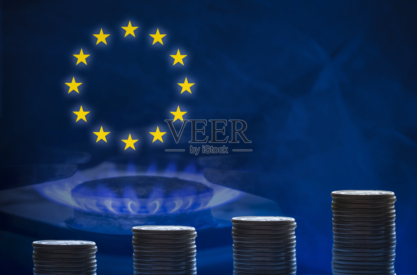 硬币堆积在燃烧的煤气炉上。这个概念是供应成本，天然气的支付。照片摄影图片