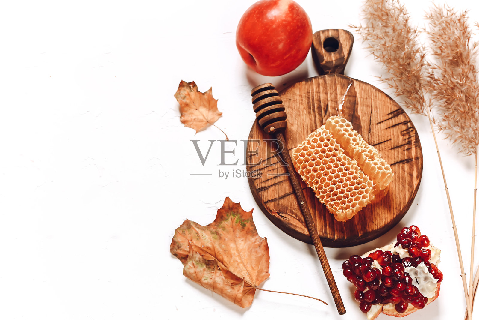 石榴、苹果和蜂蜜。秋天的成分。传统的犹太节日新年。罗什的新年快乐。照片摄影图片