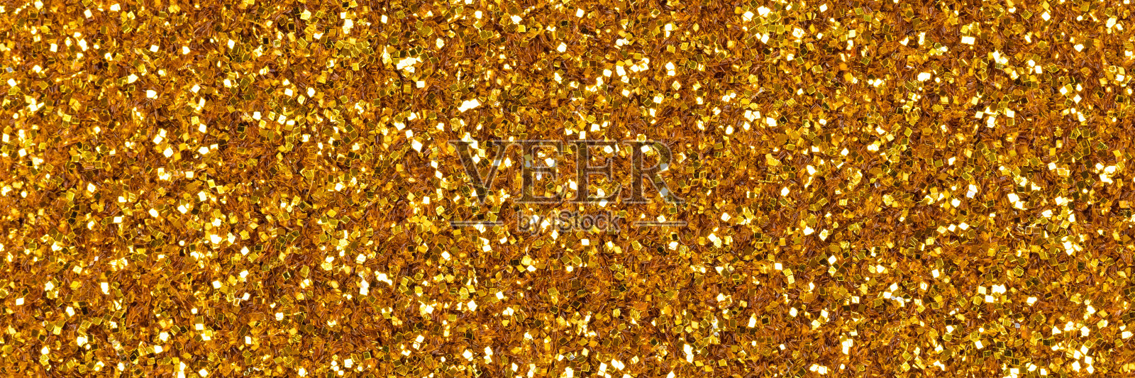 优雅的金色闪光质地，长背景具有迷人的金色光泽。照片摄影图片