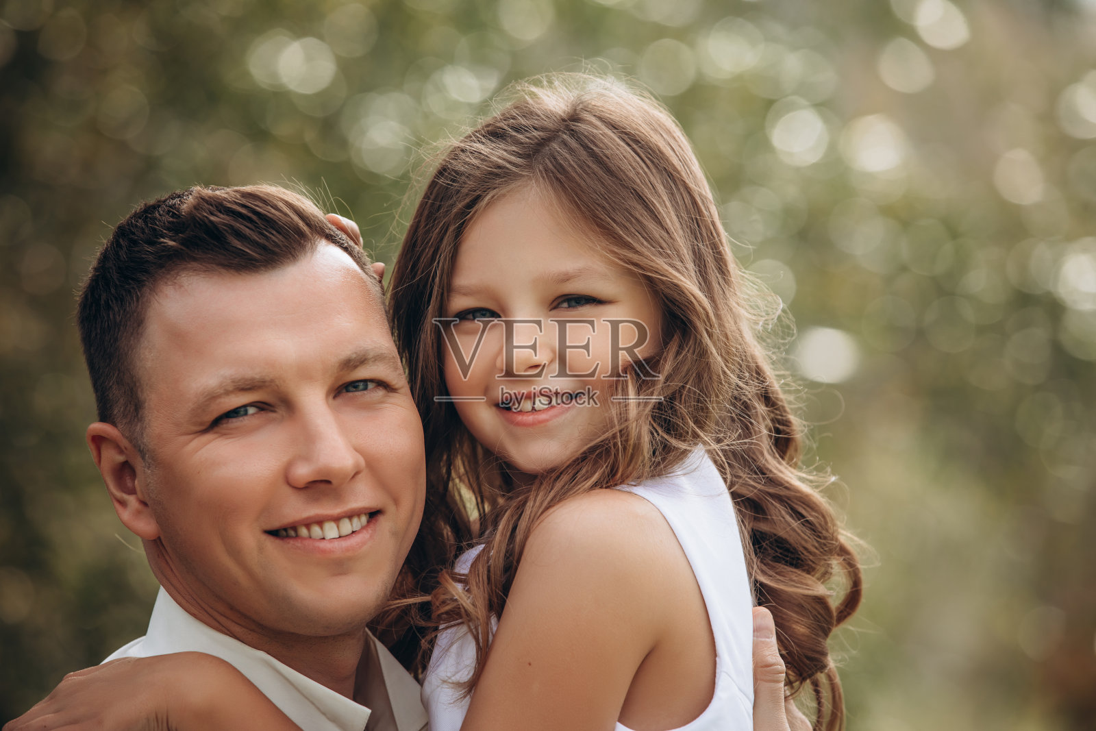 一家人的父女在一起美丽快乐，穿着白色的衣服，在大自然中照片摄影图片