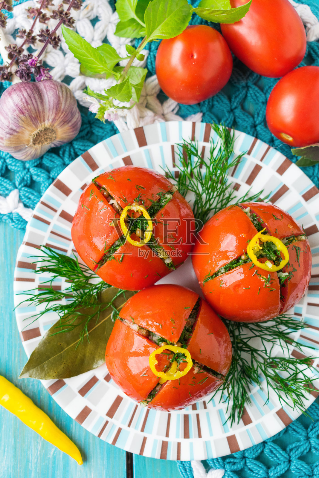 腌西红柿配辣椒和莳萝。西红柿的冷开胃菜。腌制西红柿照片摄影图片