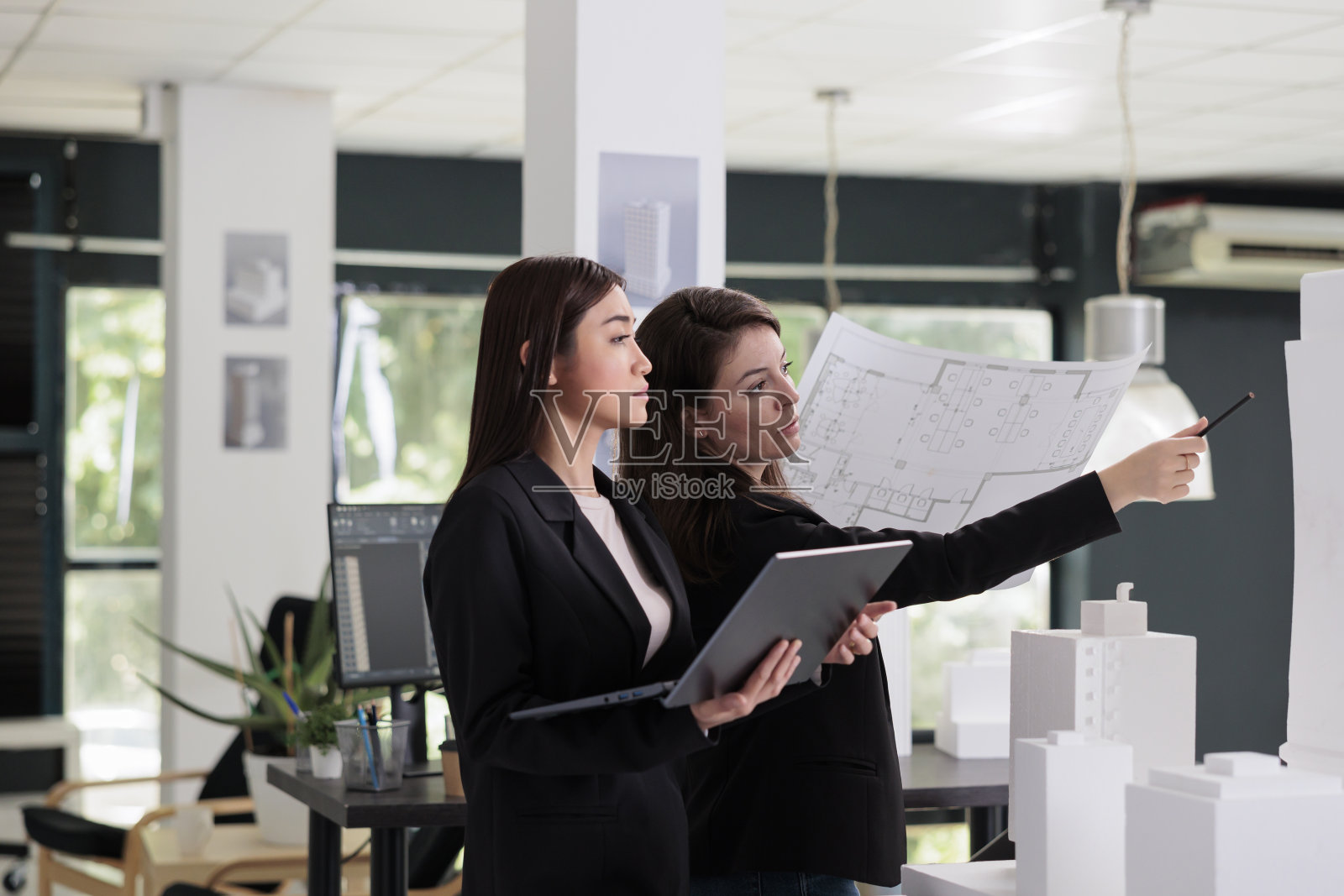 建筑师手持蓝图，与建筑施工项目一起工作照片摄影图片