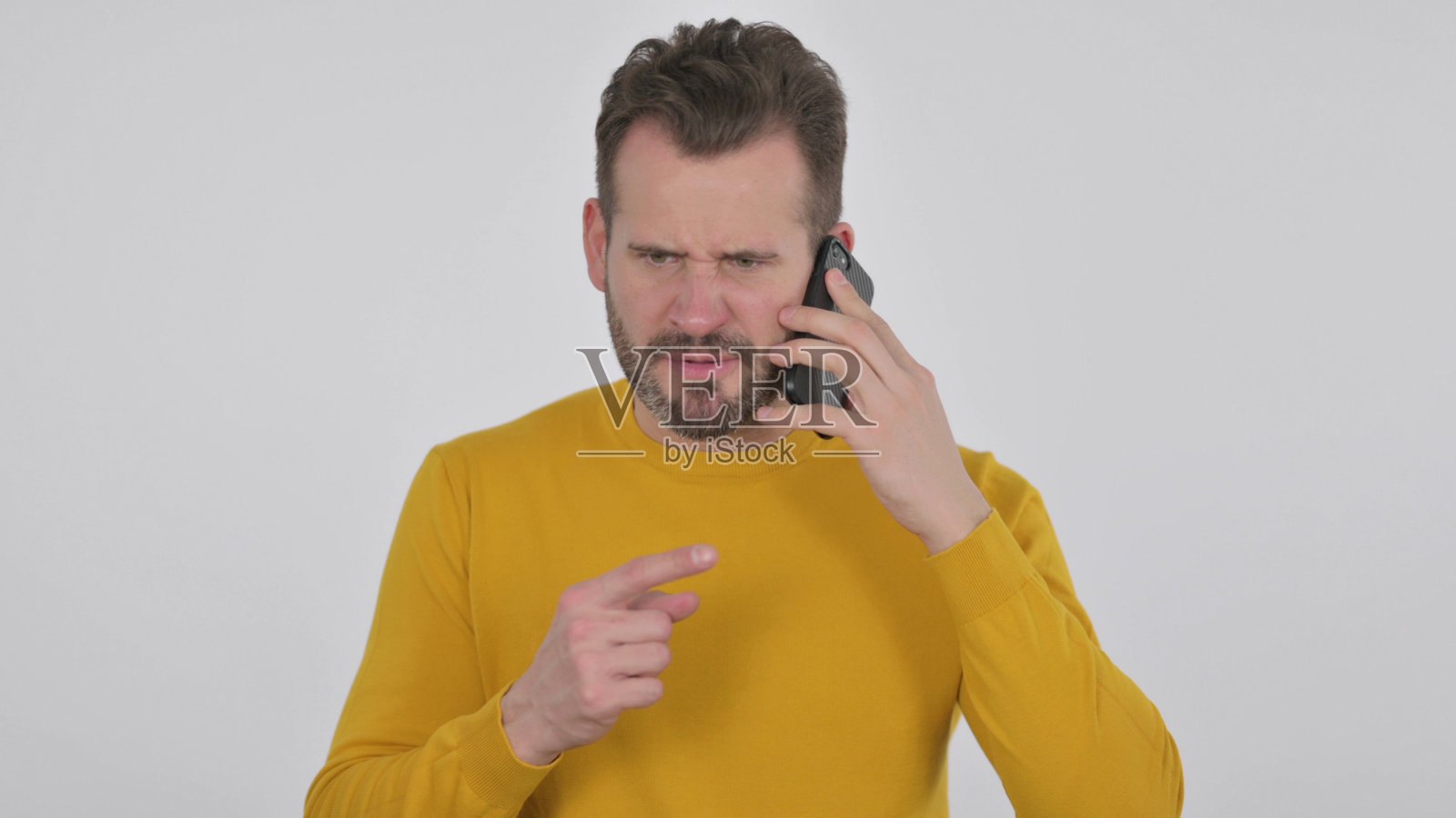 愤怒的中年男子在白色背景下用智能手机说话照片摄影图片
