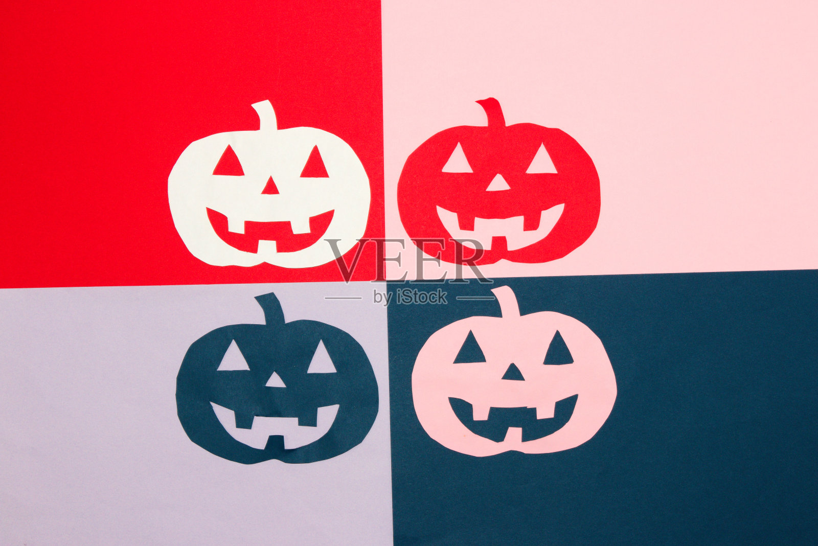 彩色背景分为4部分，用彩色雕刻的南瓜，创意万圣节概念，平铺照片摄影图片