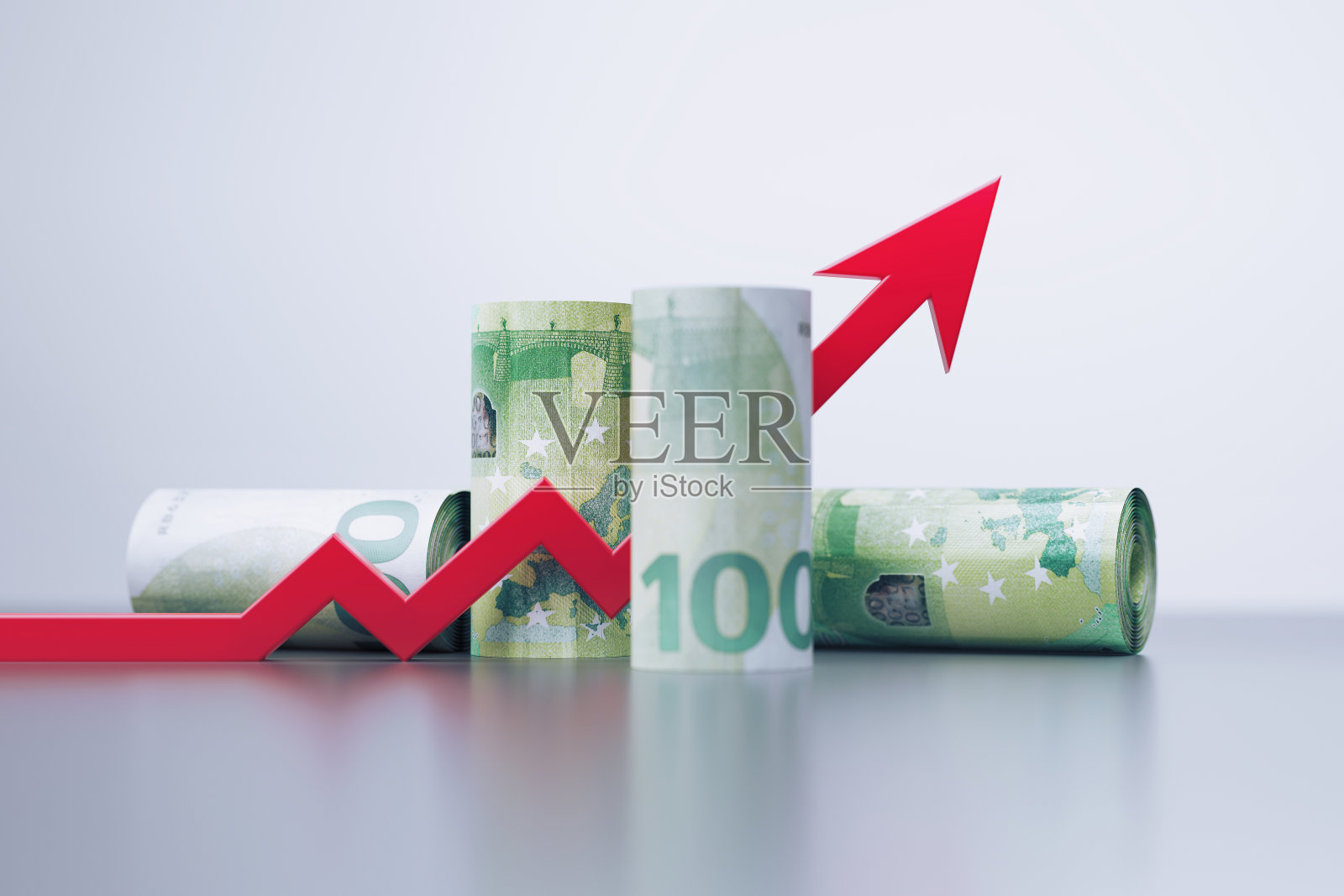 卷起来的100欧元钞票和红色箭头符号坐在灰色背景照片摄影图片