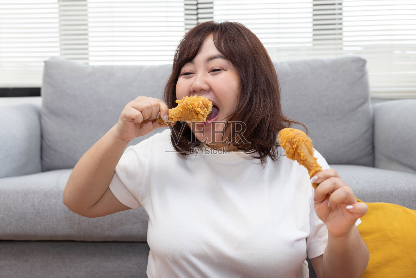胖女人喜欢吃炸鸡腿照片摄影图片