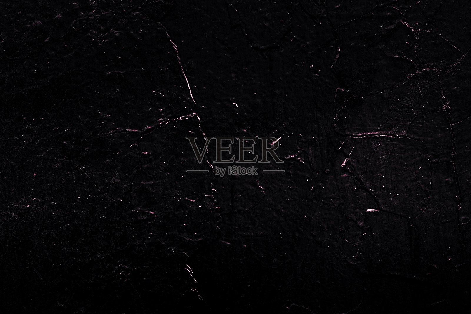 枯燥乏味的粗糙结构。黑色的纹理。石头的背景。黑暗的大理石。岩石纹理。岩石表面有裂缝。岩石堆。墙漆点。抽象的纹理。照片摄影图片