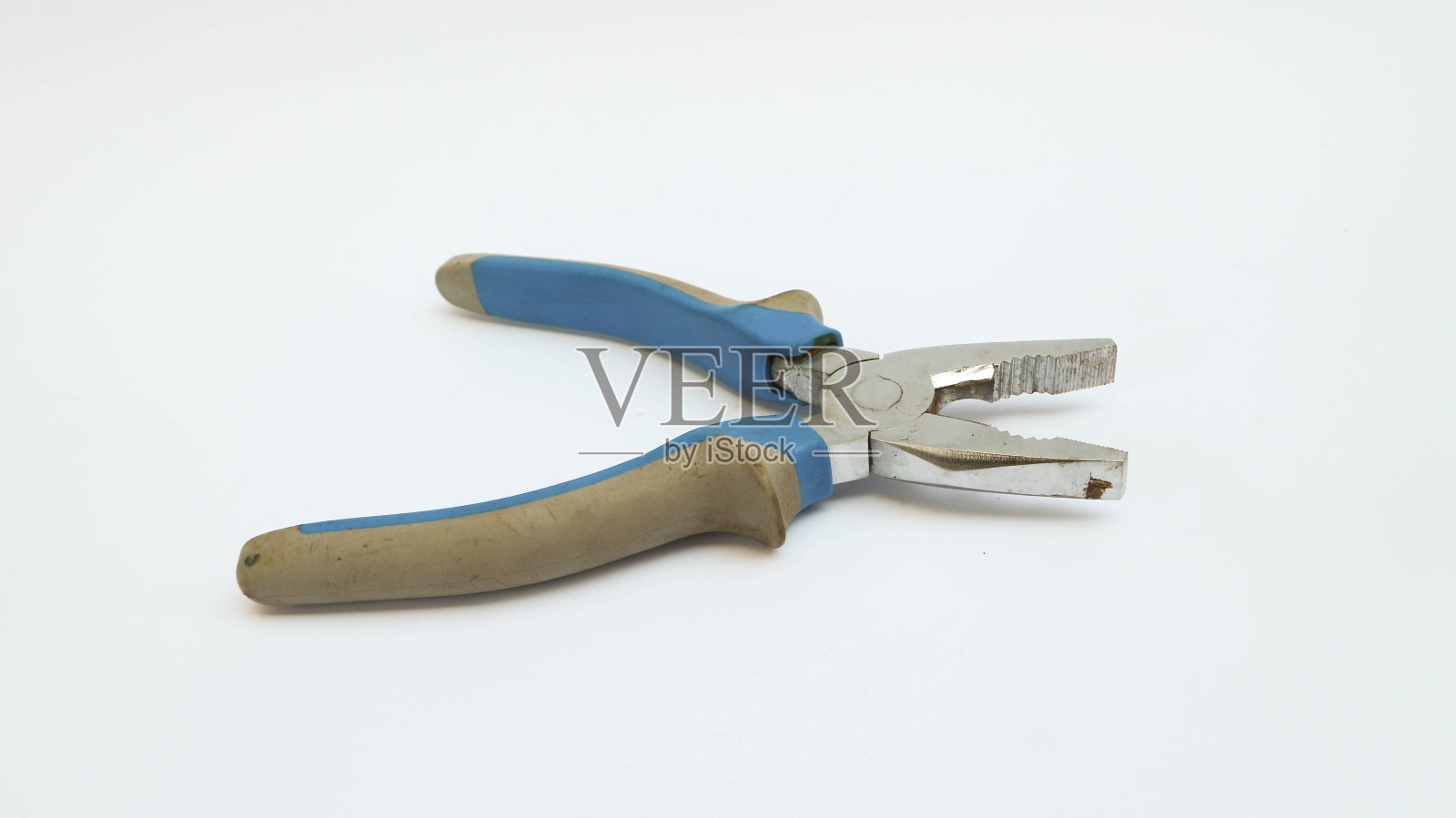 在白色背景上的蓝色和灰色的钳子照片摄影图片