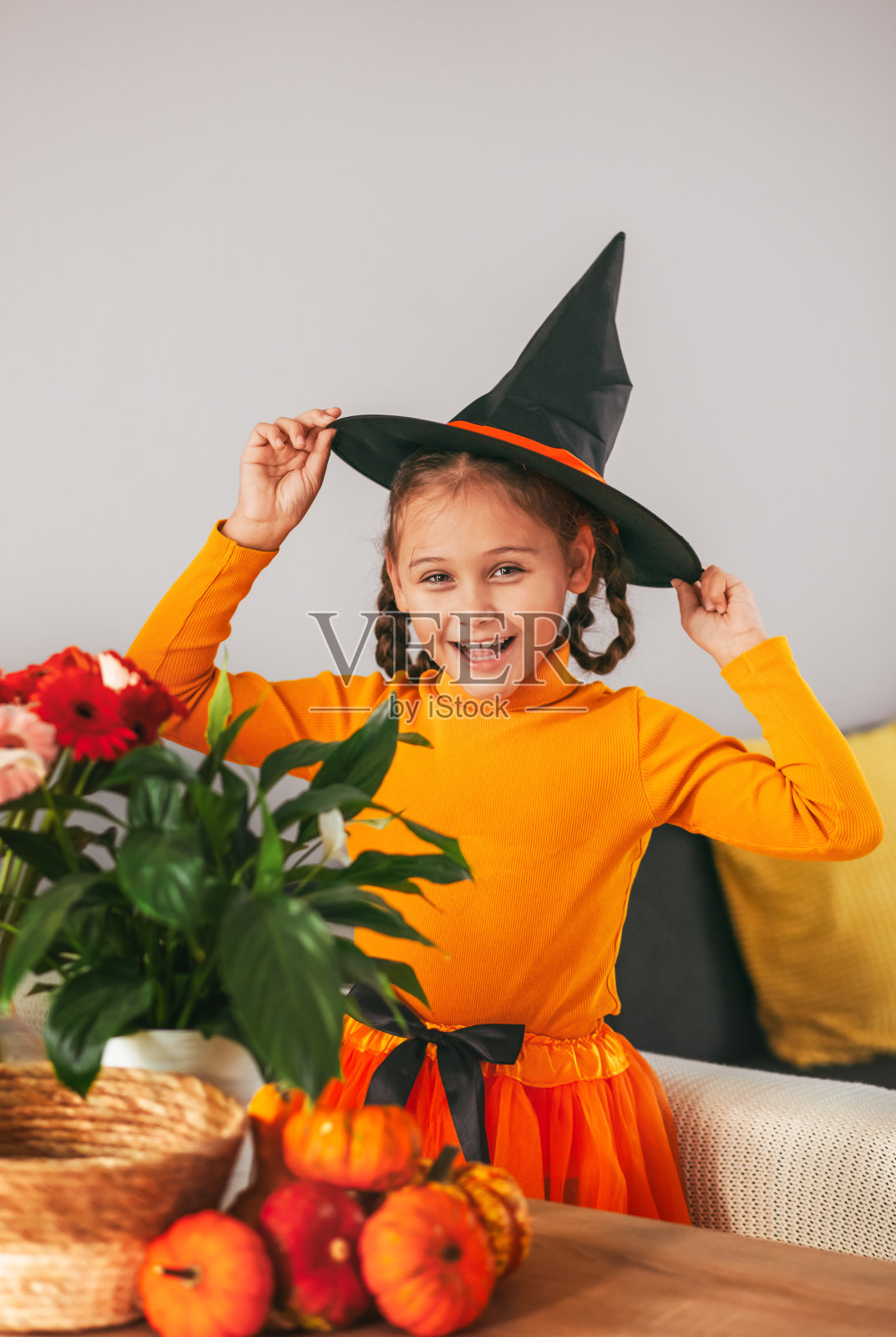 小女孩玩南瓜。家里的情感画像。万圣节派对的概念。照片摄影图片