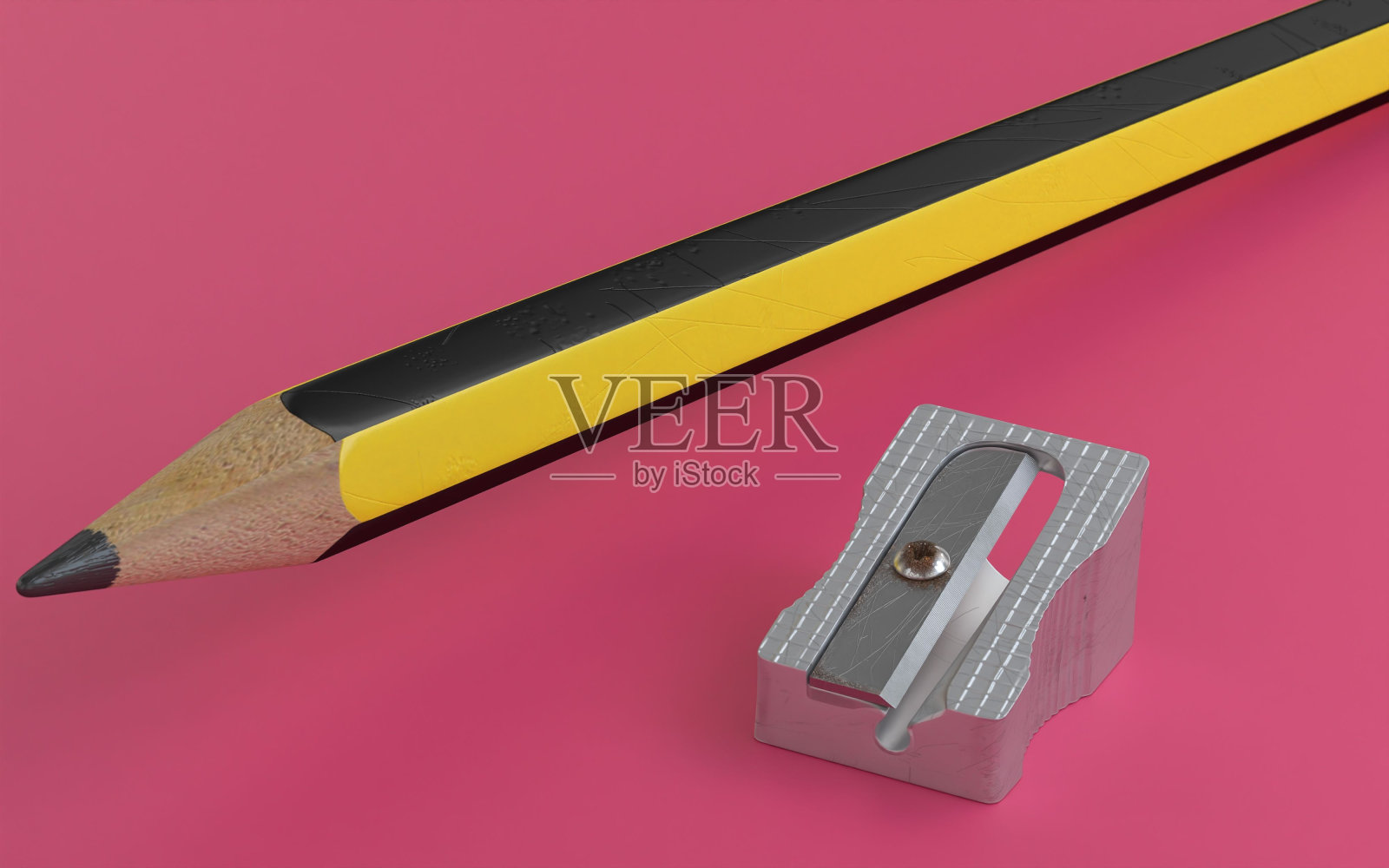 铅笔和卷笔刀被孤立在粉红色的背景上照片摄影图片