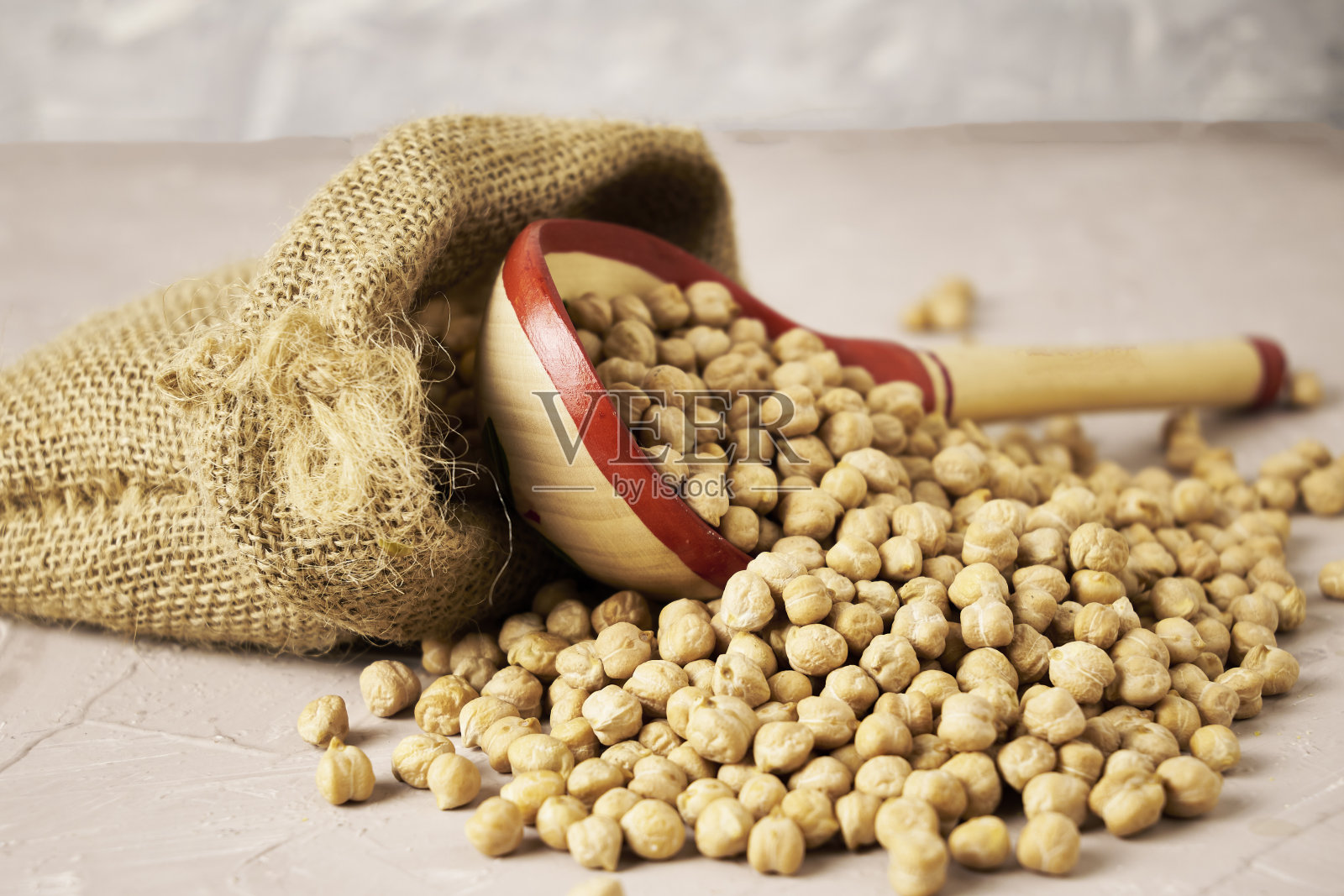 帆布袋里装着鹰嘴豆桌子上放着木勺照片摄影图片