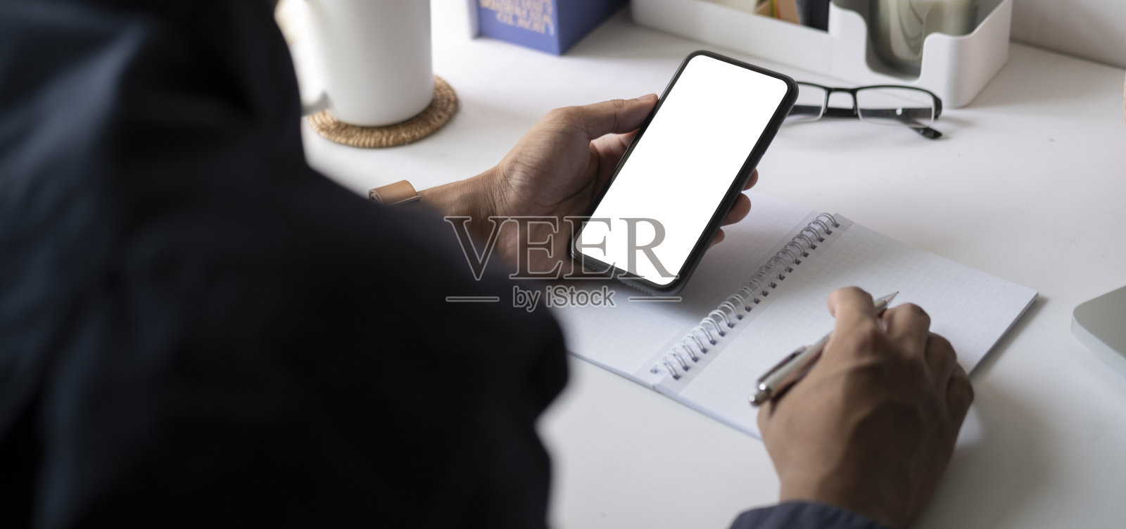 近距离观看男子手持模拟智能手机与空白屏幕。照片摄影图片