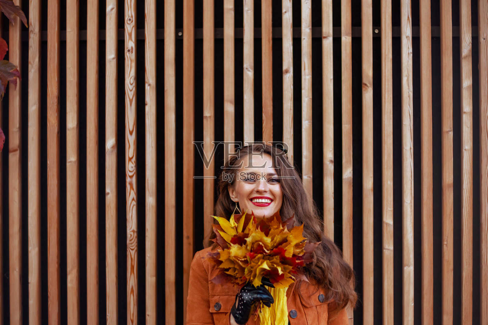 穿着橙色风衣的快乐女人照片摄影图片